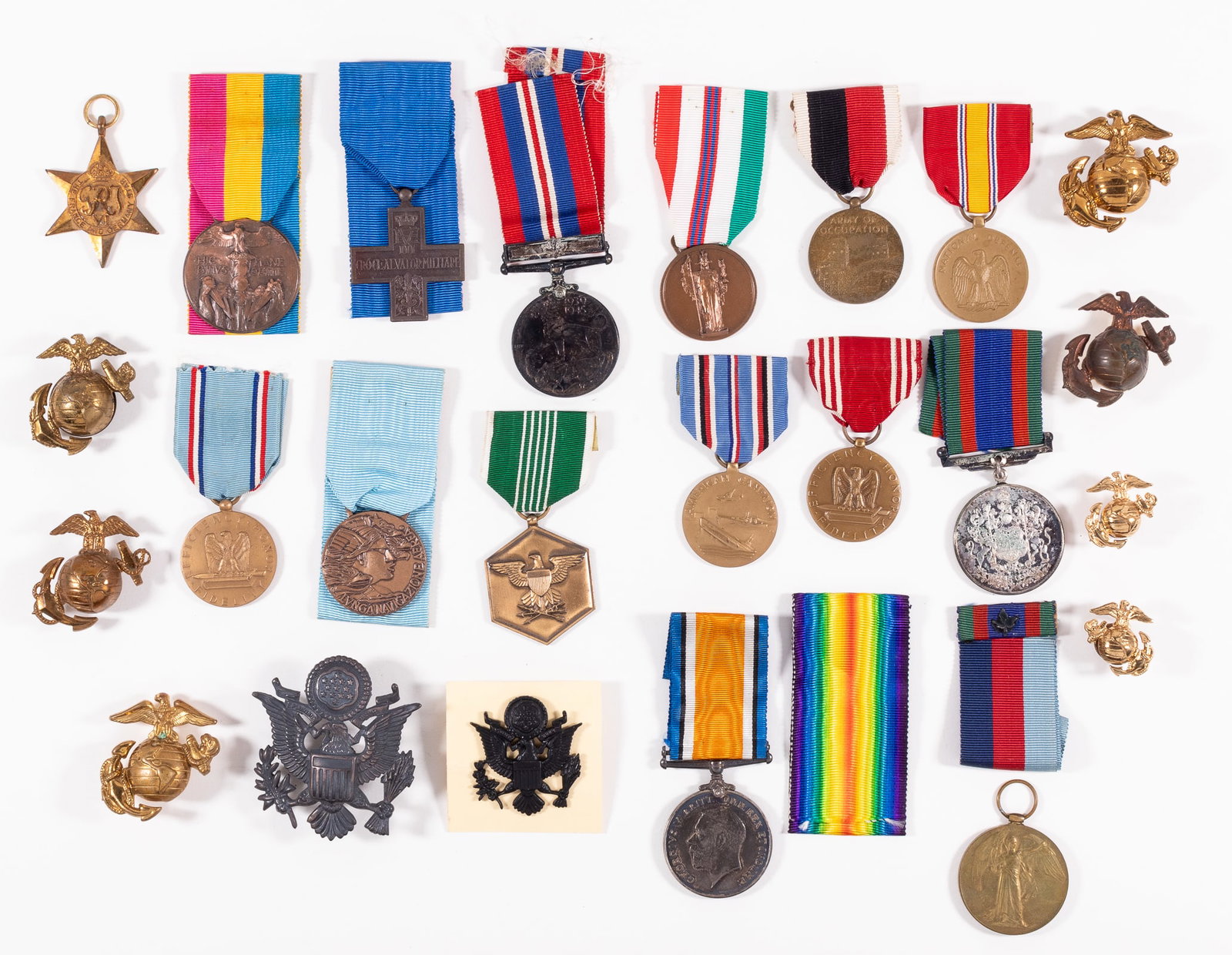 20 ALLIED MEDALS AND INSIGNIA BADGES: Lot of 20 Allied medals and insignia badges, including a Military Merit medal, marked Johnny V. Refeld on the reverse, a National Defense medal, two Good Conduct medals, one for the Army and one for t