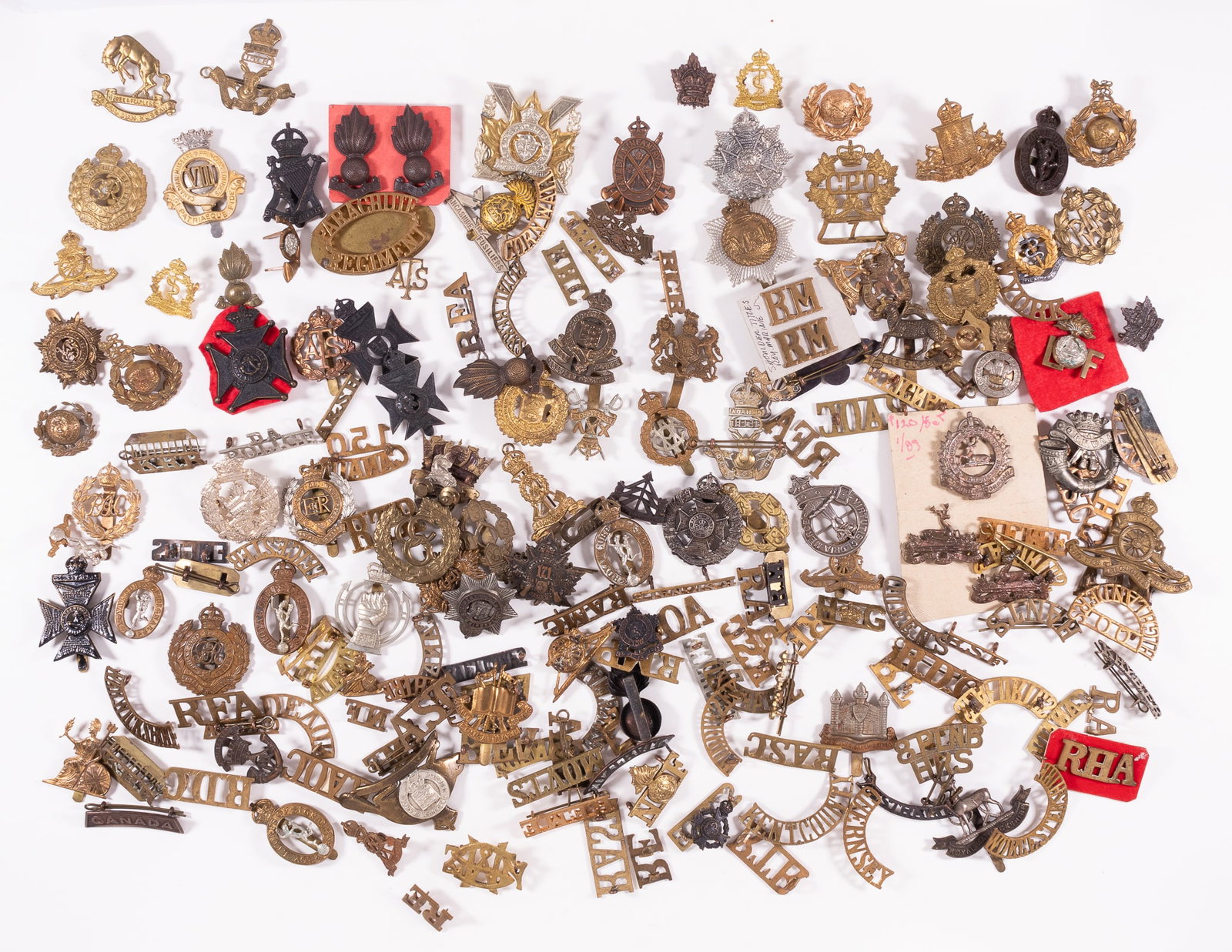 180 WWI WWII BRITISH CANADIAN AND AUSTRALIAN BADGES: Lot of 180 WWII British, Canadian, and Australian regimental and unit badges, including Signal Corps badges, Canadian Infantry badge, Lancashire Fusiliers badge, and more. Sold as is, large dealers lo