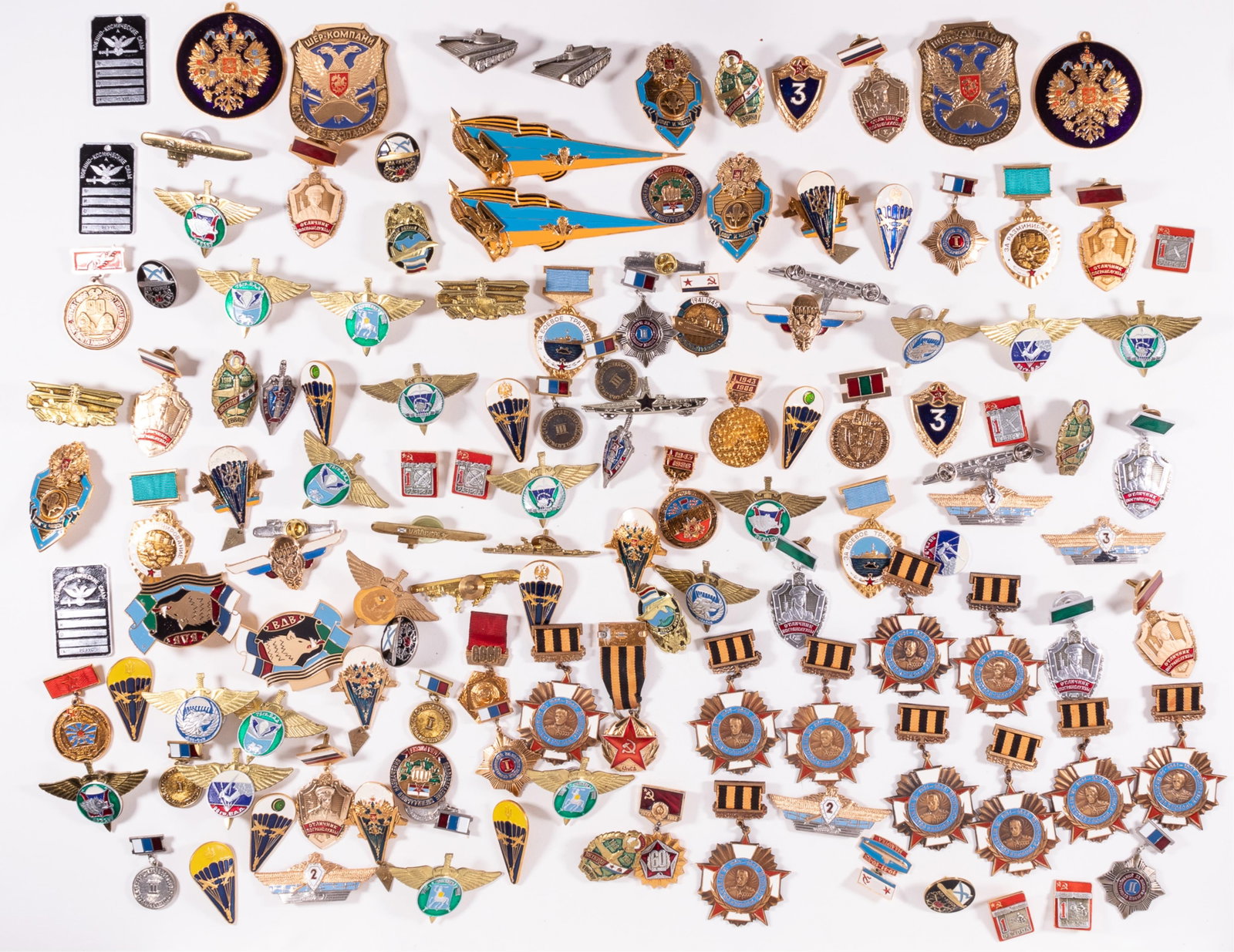 130 RUSSIAN BADGES AND MEDALS: 130 Russian badges and medals, including wings, parachutist badges, and more, featuring different insignia. Includes ten Russian Marshal Zhukov medals, '100 Years to Marshall Zhukov.' Most screwback p
