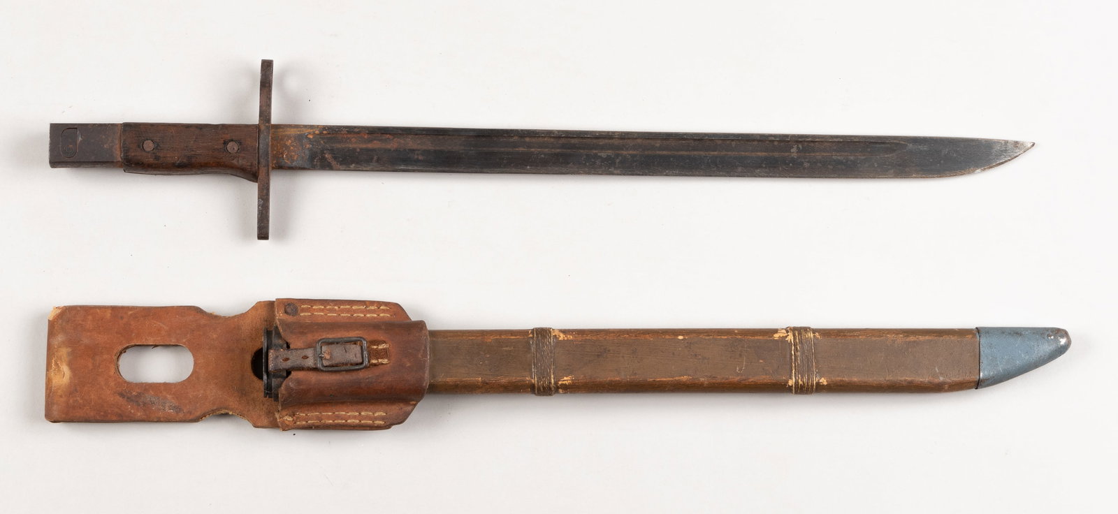 WWII JAPANESE TYPE 30 LAST DITCH BAYONET FROM TOYODA: WWII Japanese type 30 last ditch bayonet and scabbard, marked on the ricasso with the maker mark for Toyoda Automatic Loom Works, partially illegible from oxidation, known as Toyota today, with a wood
