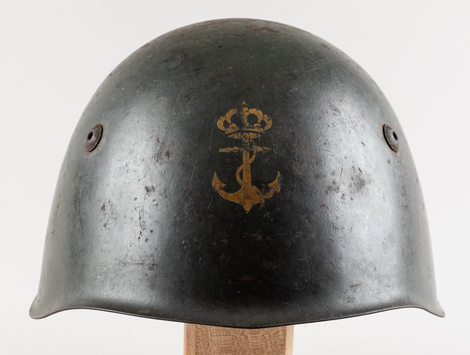 WWII ITALIAN M33 NAVY DECAL HELMET: WWII Italian M33 Navy decal helmet with leather liner. Marked on the back rim of the rim 'SRM,' with a yellow anchor emblem on the front for the Italian Navy. No maker marks are prevalent. With leathe
