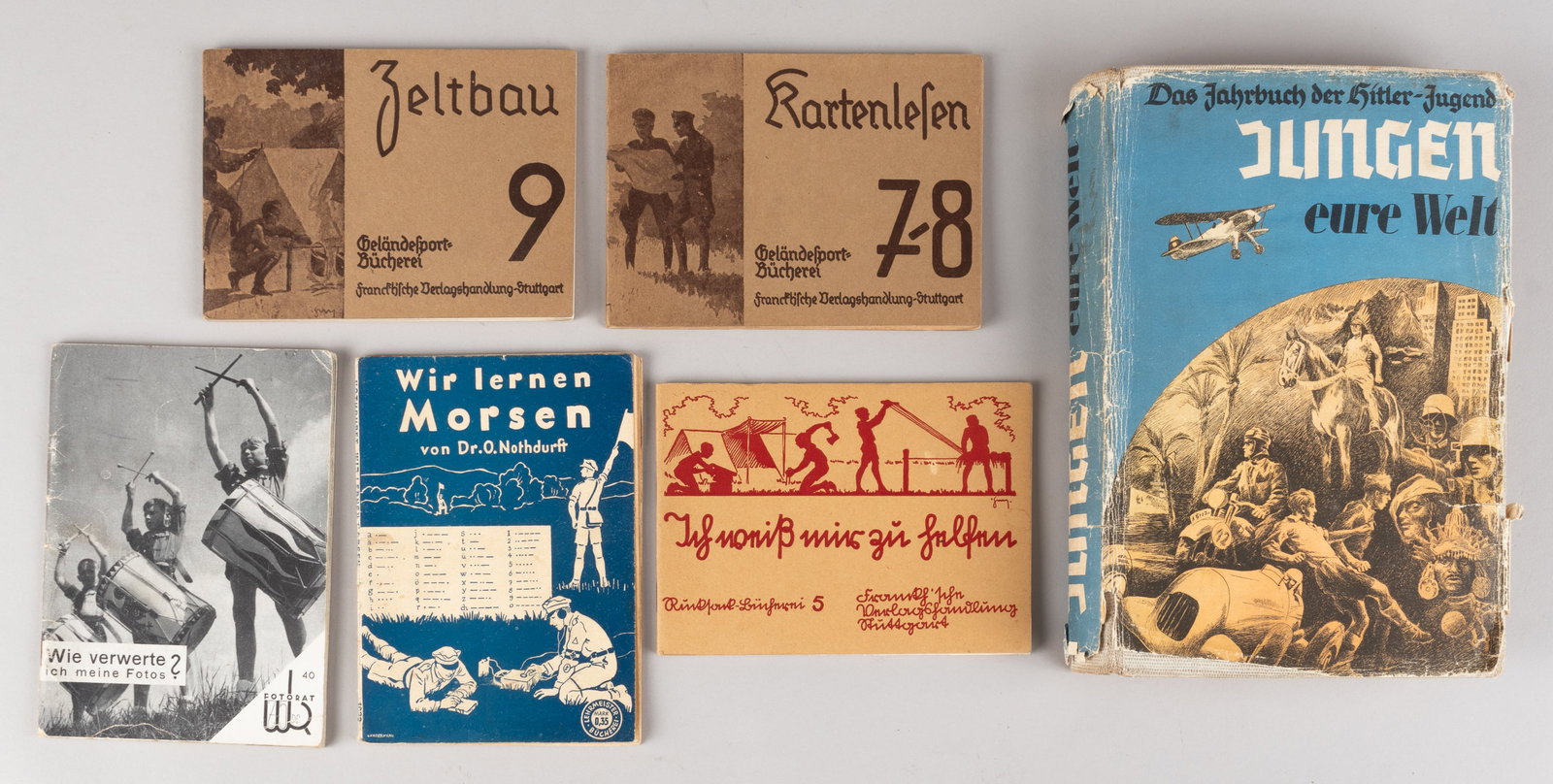6 GERMAN THIRD REICH HITLER YOUTH PROPAGANDA BOOKS: Lot of six German Third Reich Hitler Youth propaganda books, including 'The Hitler Youth Yearbook' 1938, 'How Do I Use My Photos,' 1938, 'We Learn Morse Code,' 'Tent Construction,' 1933, 'Map Reading,