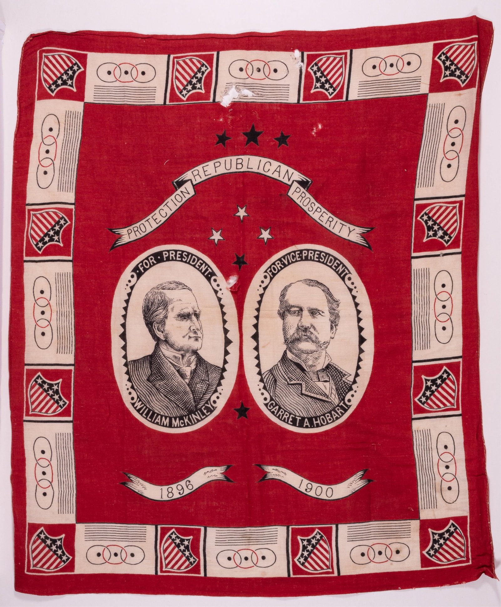 1896 MCKINLEY & HOBART POLITICAL CAMPAIGN BANDANA W/ 2 AUTOGRAPHS BY HOBART: 1896 presidential election bandana for William McKinley for President and Garret A. Hobart for Vice President. Red field, center portraits of William McKinley and Garrett Hobart, motto above 'Protecti