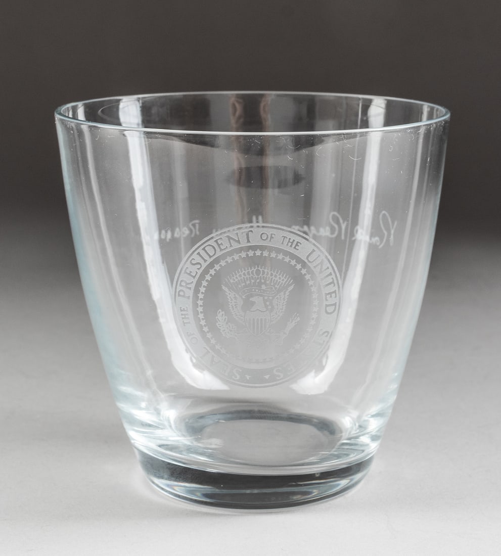 RONALD REAGAN PRESIDENTIAL TUMBLER: Ronald Reagan Presidential tumbler, bears an engraved presidential seal on one side with facsimile signatures from both Ronald Reagan and Nancy Reagan on the reverse. Likely submitted to the White Hou