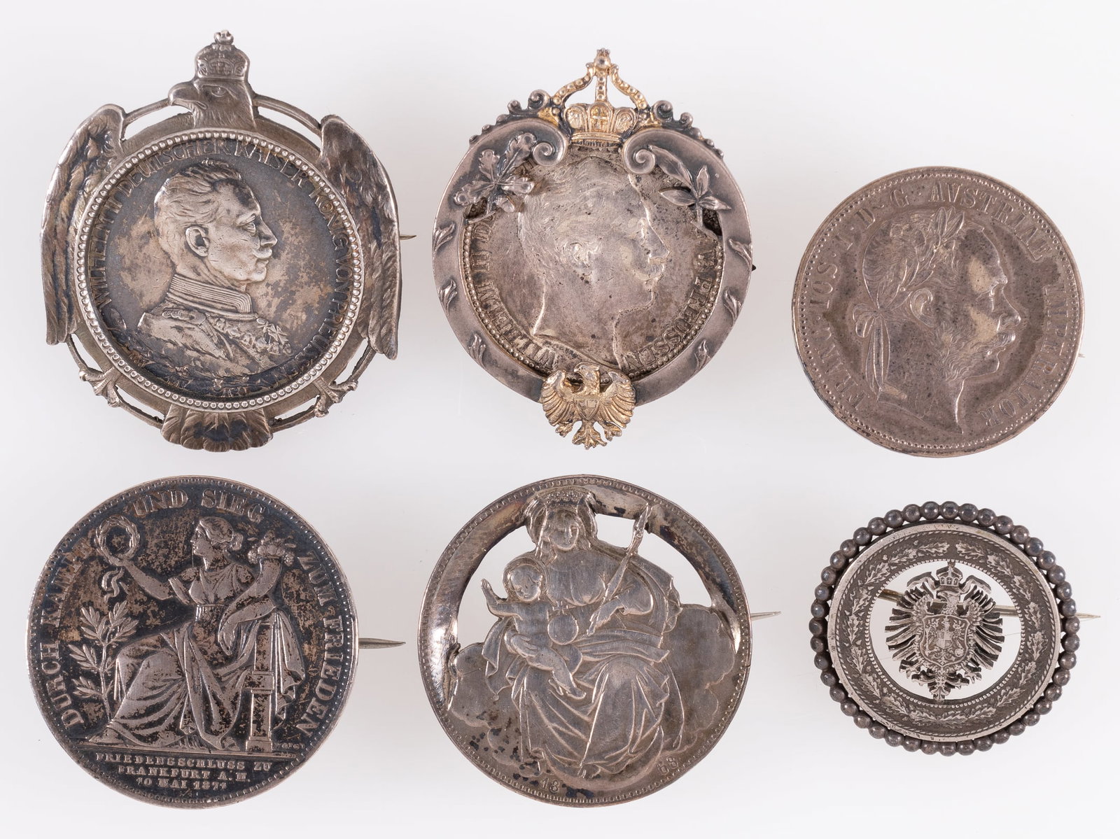 6 AUSTRIAN COMMEMORATIVE SILVER COIN BROACHES: Six Austrian commemorative broaches, each a commemorative silver Austrian coin, including Deutches Reich coins, Koenig, and Hungary coins. Each coin has a pinback attached to the back or in a coin bro