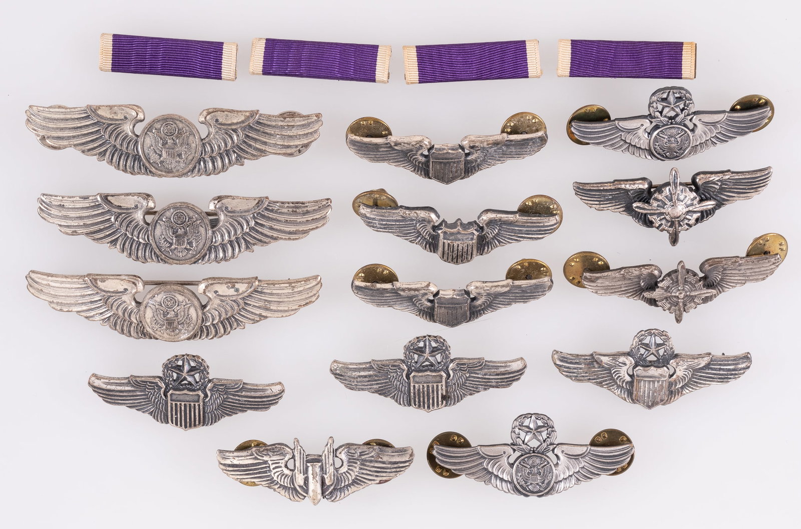 14 AMERICAN PILOT AND AIR CREW WINGS: Forteen American pilot wings and air crew wings badges, including three Pilot wings, three Command Pilot wings, three Aircrew wings, two Master Aircrew wings, one Aerial Gunner wings, and two Flight E