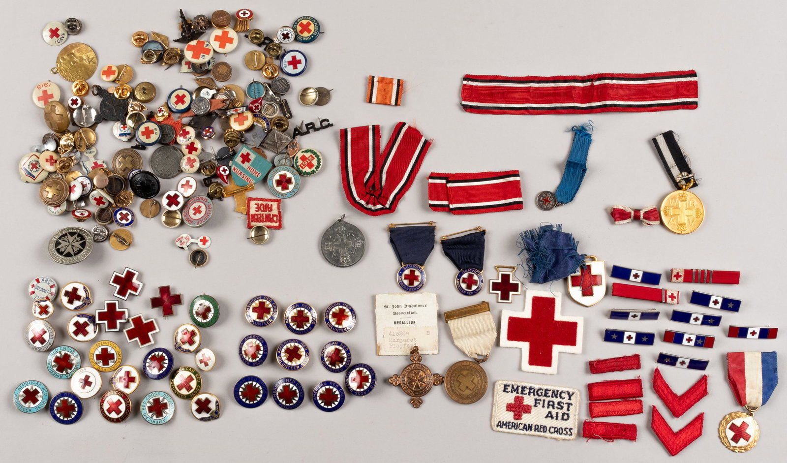 193 WWI + WWII RED CROSS PINS AND BADGES: Lot of 193 WWI and WWII Red Cross pins and badges, large assorted mix, some include a St. Johns Ambulance Association medal, marked on the back '416299 Margaret Playford - Registered at St John's Gate