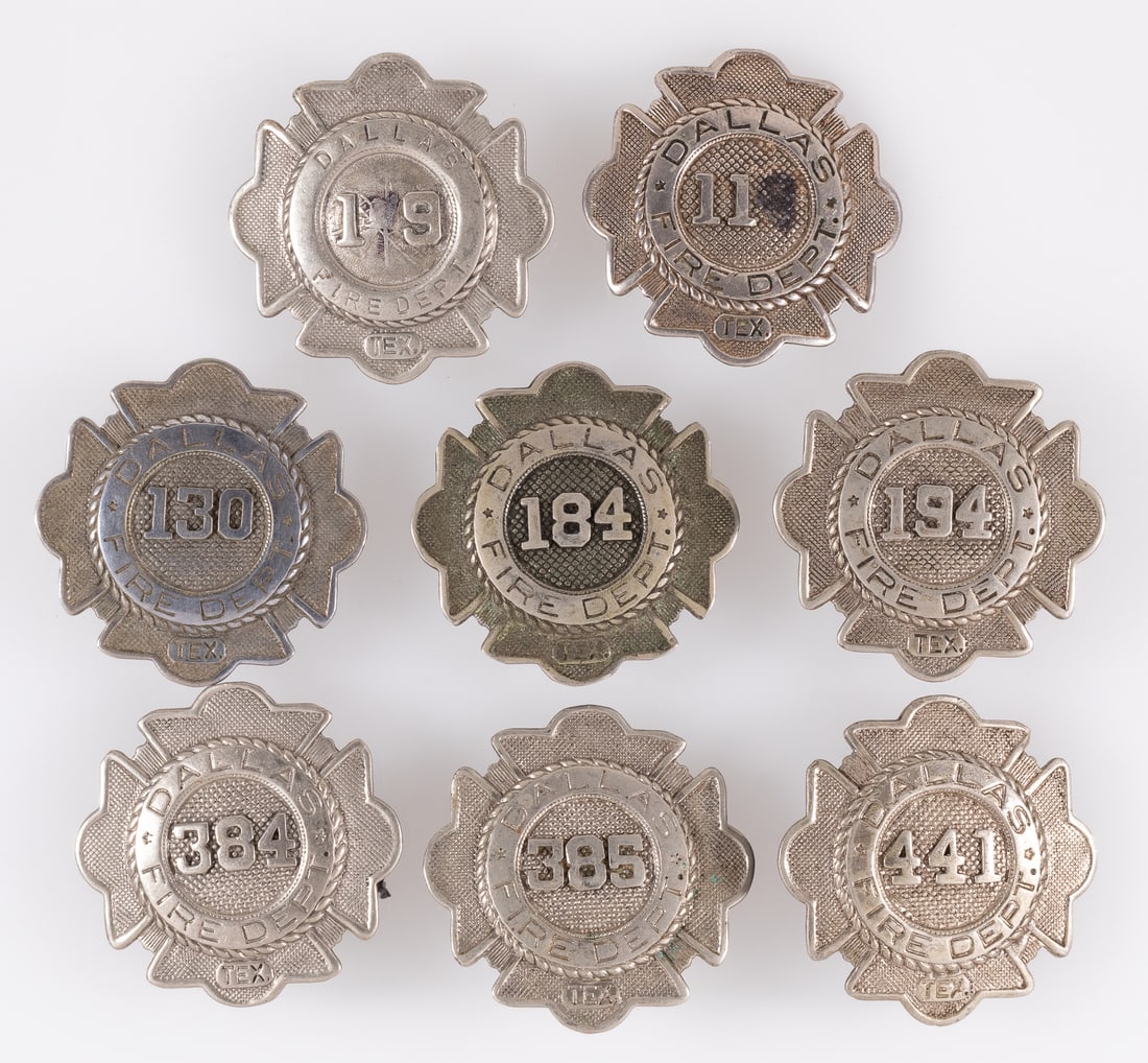 8 OBSOLETE DALLAS TEXAS FIRE DEPARTMENT BADGES: Eight obsolete Dallas Texas fire department badges, each reads 'Dallas Fire Department Tex,' with a number in the center. One missing a number in the center, and the one with '19' has a ladder and hel