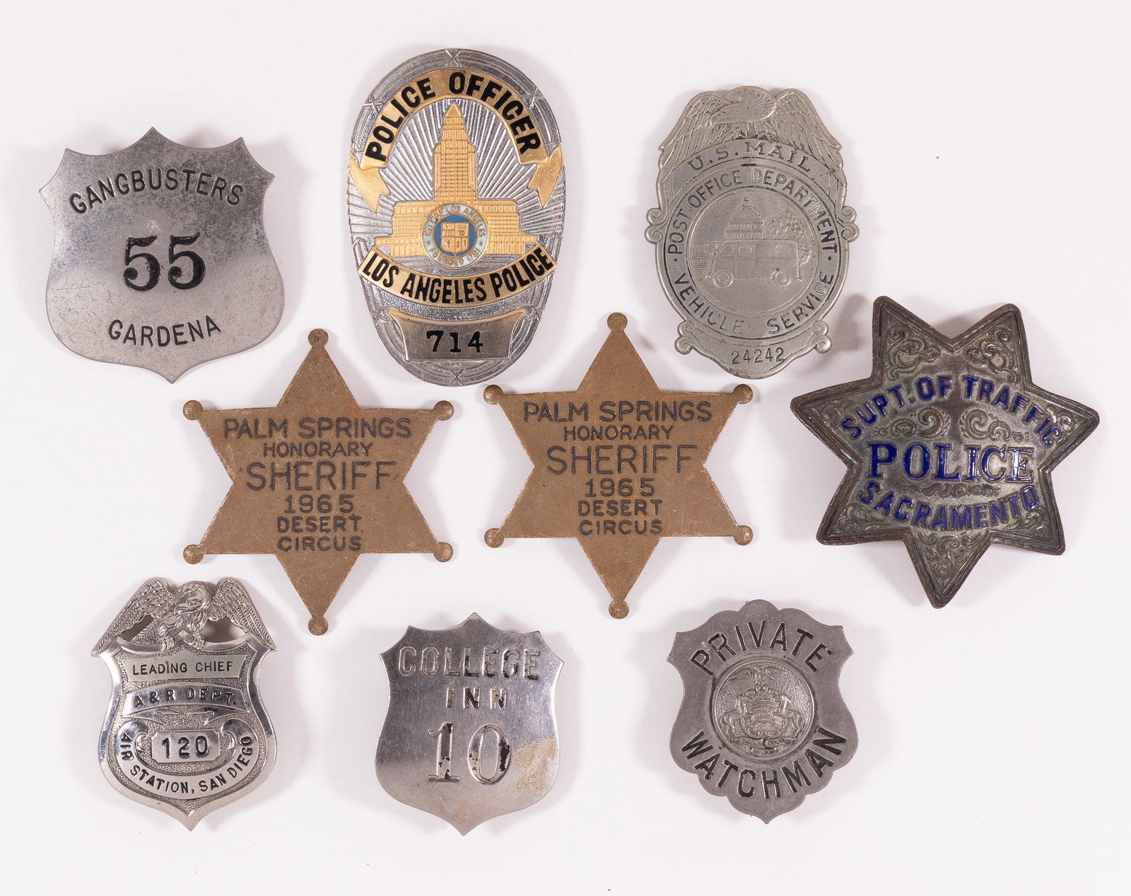 9 OBSOLETE CALIFORNIA SERVICES BADGES: Nine obsolete California services badges, including two 1965 Palm Springs Honorary Sheriff badges, Los Angeles Police Officer badge, Gardena Gangbusters badge, a Private Watchman badge, a US Mail Vehi