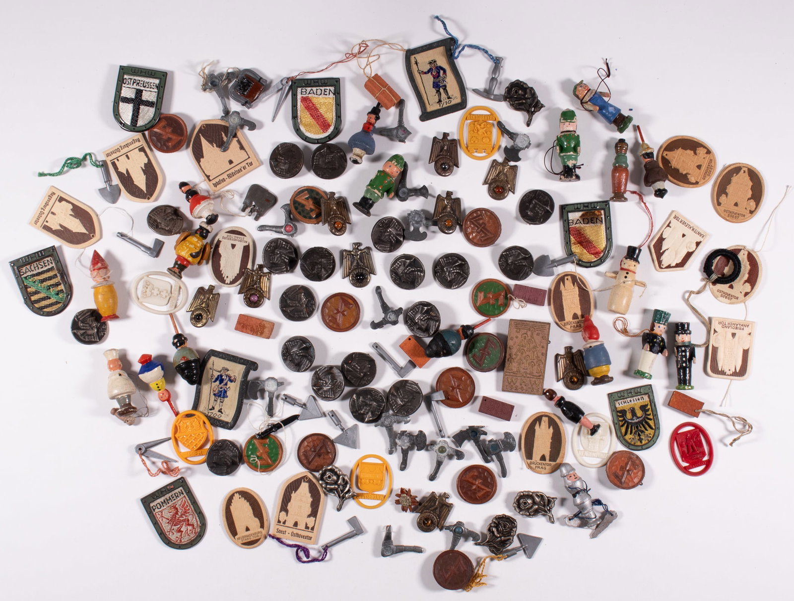 125 WHW WINTERHILFSWERK DONATION TOKENS: Approx. 125 WHW Winterhilfswerk donation tokens, some displaying famous buildings and cities in Europe, Hitler Youth tools, wooden figures, Frederich the Great, butterflies, and many more. Some missin