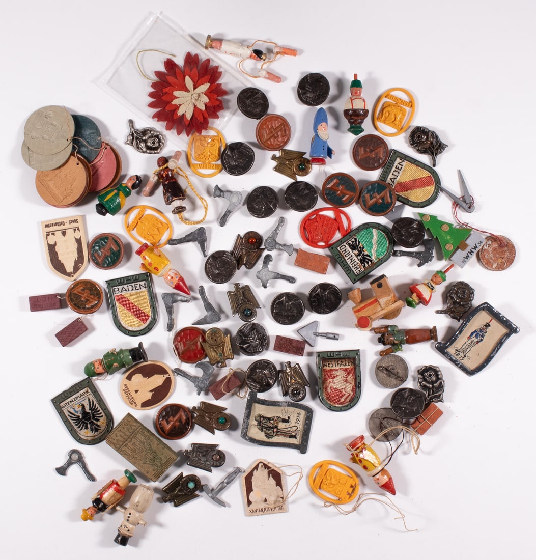 125 WHW WINTERHILFSWERK DONATION TOKENS: Approx. 125 WHW Winterhilfswerk donation tokens, some displaying famous buildings and cities in Europe, Hitler Youth tools, wooden figures, Frederich the Great, and many more. Some missing their pinba