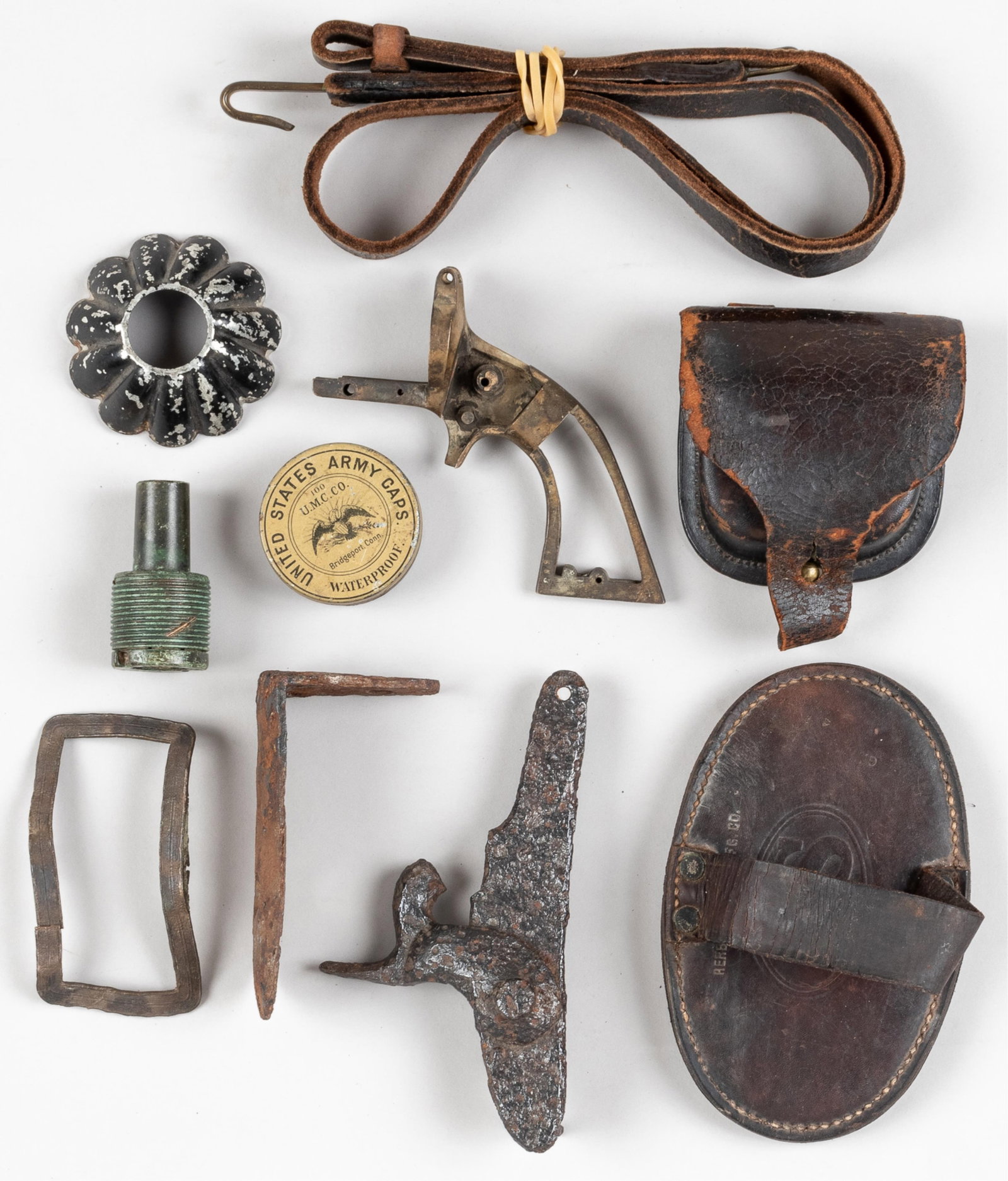 US CIVIL WAR RELICS AND DUG ITEMS (10 PIECES): Small collection of ten US Civil War relics and dug items, including a musket leather cap box, marked Sharp Ordnance on the front cover, US Army copper firing caps, in U.M.C. Bridgeport Conn. containe