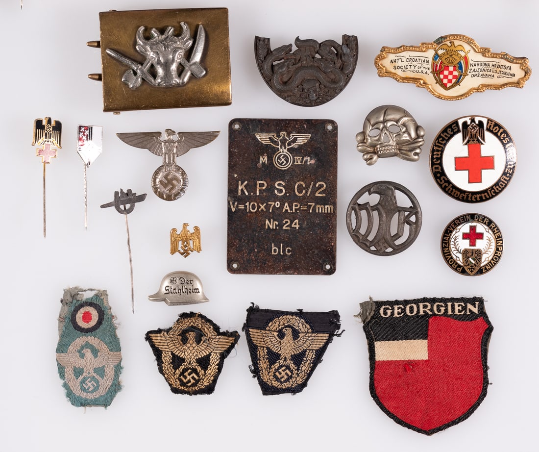 16 WWII GERMAN BADGES AND INSIGNIA: Sixteen WWII German badges and insignia, including half of the Anti-Partisan badge in bronze, with most snakes attached, a Panzer Totenkopf collar tab badge, three Schultzepolezi cap insignia, an SA c