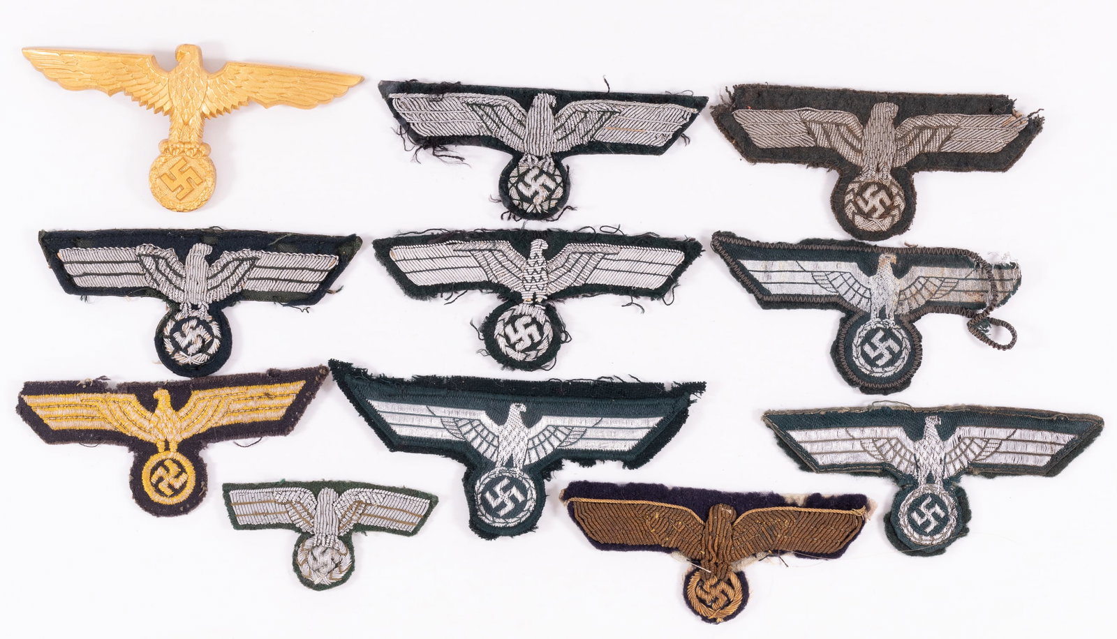 11 WWII GERMAN HEER EAGLE INSIGNIA: Eleven WWII German Heer insignia patches, including 4 machine-embroidered eagles, six bullion eagles, and an Eagle insignia badge. Dealers lot, sold as-is, no returns.