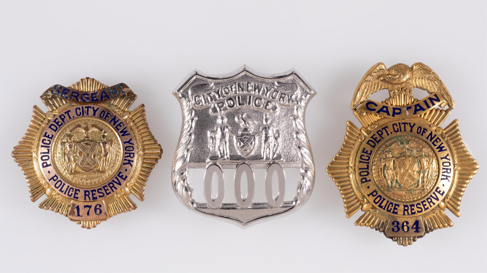 3 NEW YORK CITY OBSOLETE POLICE BADGES: Three New York City obsolete police badges, including a Police Reserve Captain badge, a Police Reserve Sergeant badge, and a City of New York Police badge. Sold as-is.