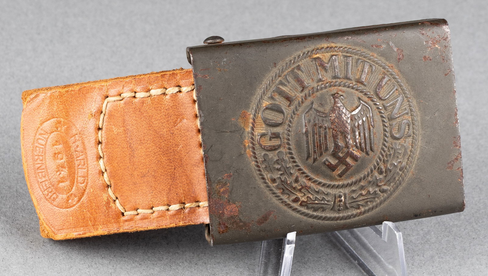 WWII GERMAN HEER BELT BUCKLE H. ARLD 1941 NUERNBERG W/ LEATHER TAB: Tabbed Heer belt buckle marked on the reverse near the catch 'H. A. 41,' with attached leather tab embossed 'H. Arld 1941 Nuernberg.' Steel construction with original 'Feldgrau' painted finish, minor
