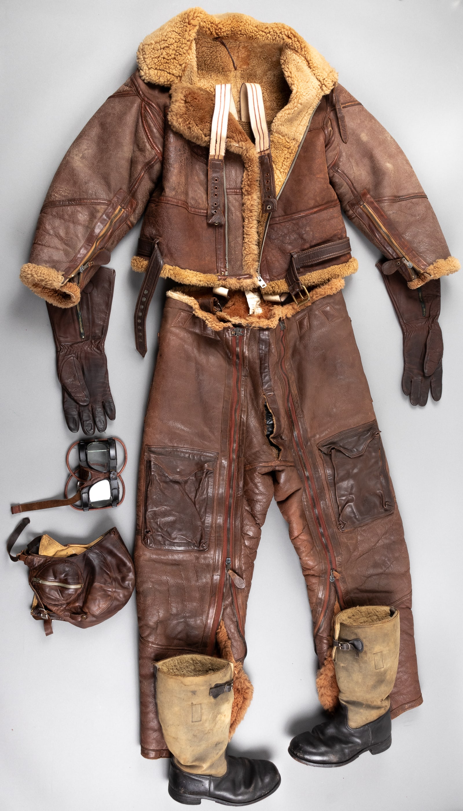 WWII CANADIAN NAMED LEATHER FLIGHT OUTFIT: WWII Canadian R.C.A.F. named leather flight outfit, with sheep skin bomber jacket, on the front vest in white reads 'P.J. Rubben R.C.A.F.,' leather exterior with sheepskin wool lining, deterioration t