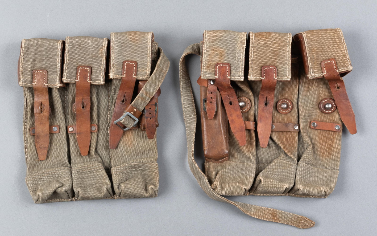 2 WWII GERMAN MP40 MAGAZINE POUCHES: Two WWII German MP40 magazine pouches, each stamped into the leather on the reverse 'WaA337' with the waffenamt eagle above, and 'dvr43.' Canvas construction bags with leather straps, each with a smal