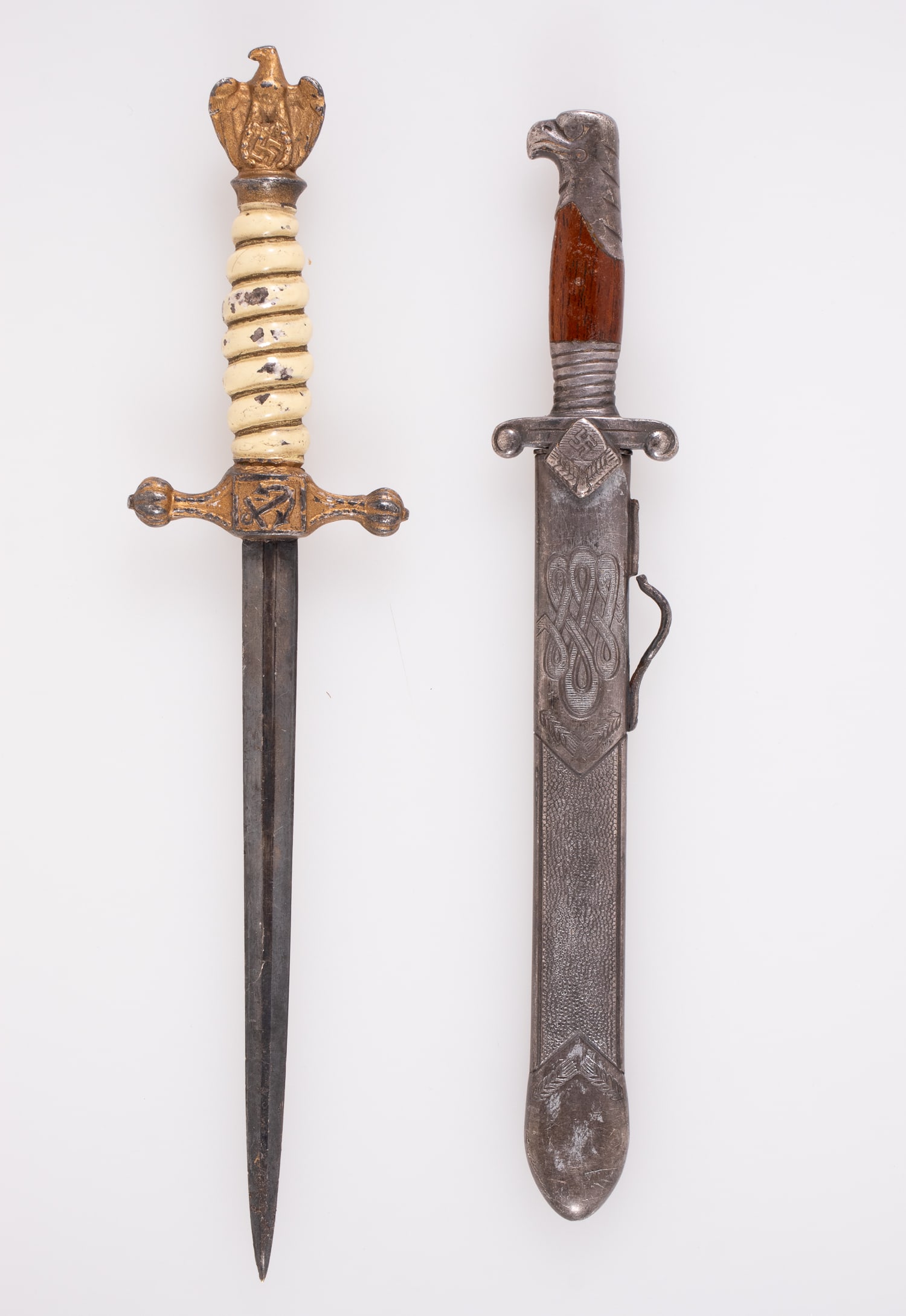 2 GERMAN MINIATURE DAGGERS: Two miniature German sample daggers, including one RAD-style dagger, marked on the ricasso 'Alcoso Solingen' blade 'Arbeit adelt,' with scabbard, a 5.25-inch long blade, 7.5 inches long total. Also in