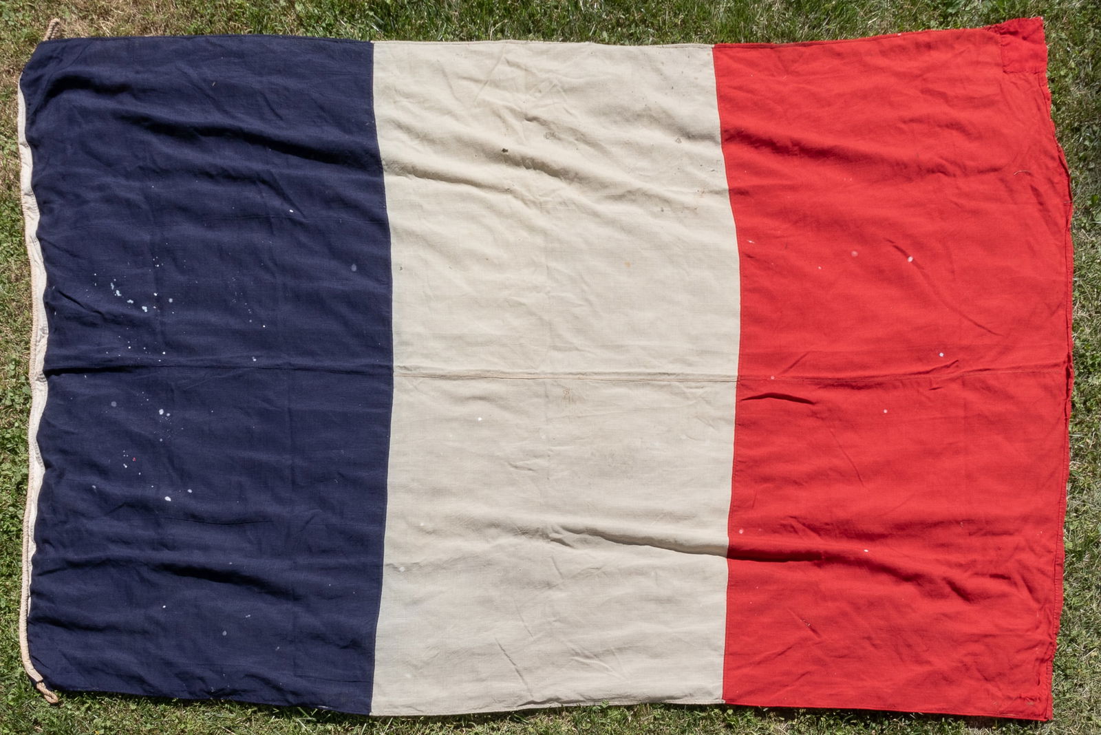 FRENCH LINE FLAGS AND SHIP SIGNS ILE-DE-FRANCE SS-LIBERTE: Flags and ship signs for the French Line shipping company, specifically for the Ile-de-France and the SS Liberte, including one Cle Gle Transatlantique house flag, 49 x 110 inches, some toning and sta