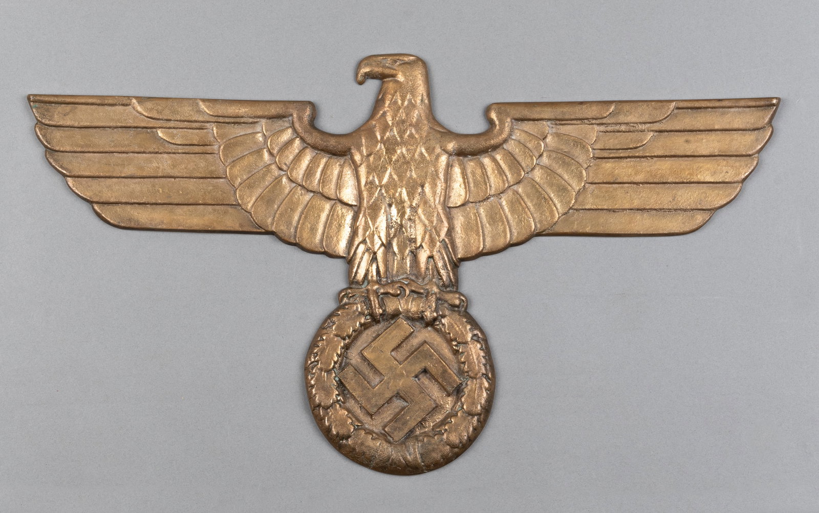 GERMAN RAILROAD EAGLE: Replica of a German railroad eagle, solid bronze cast, features a spread-winged political German eagle clutching a swastika. 22 x 12.5 inches. Weighs 9 lbs.