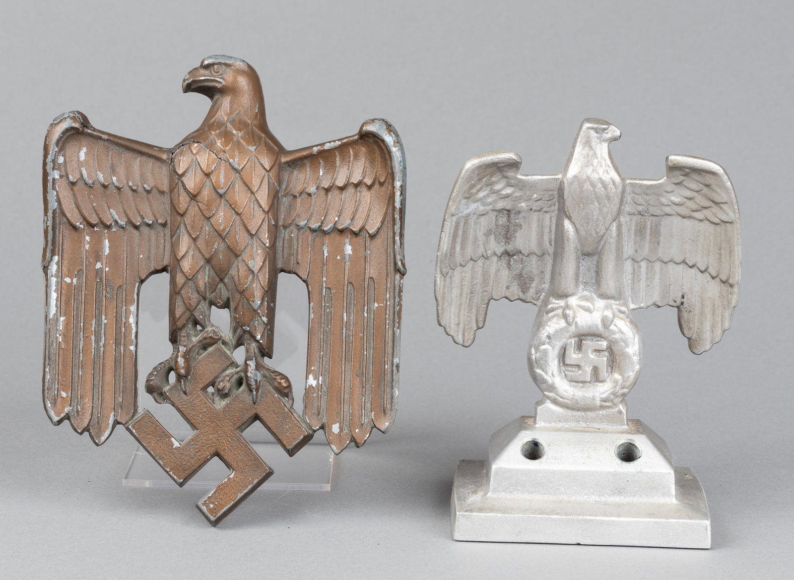 2 WWII NAZI EAGLE DISPLAYS: Two WWII Nazi eagle displays, includes one Reichsadler eagle pen holder, features a Reichsadler eagle clutching a swastika on a display stand with two holes for pens/pencils, 6 inches tall, and a Part