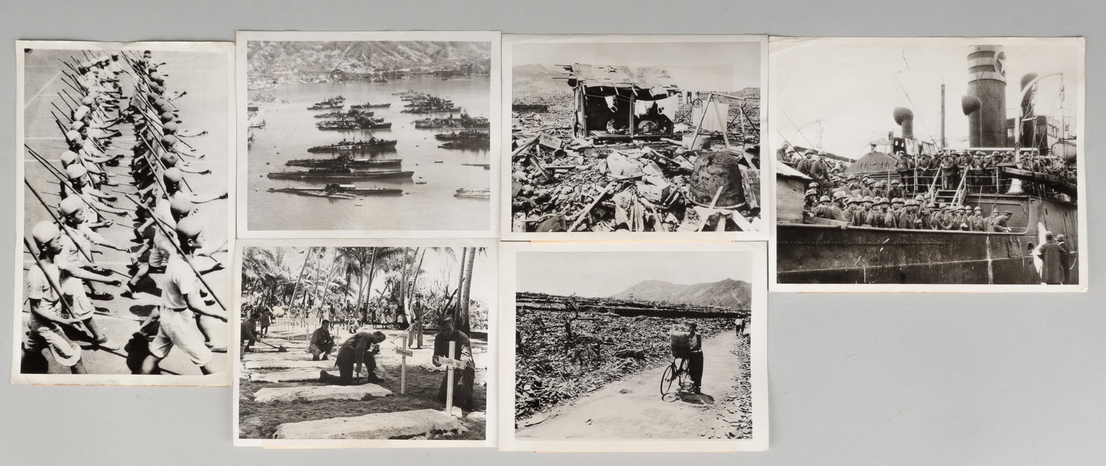 WWII NAGASAKI BOMBING AMERICAN PRESS PHOTOS: Six WWII Pacific Theater American Press photographs, each with a caption attached to the back of the photo, including two photos of the destruction of Nagasaki after the atomic bombings, one of a buri