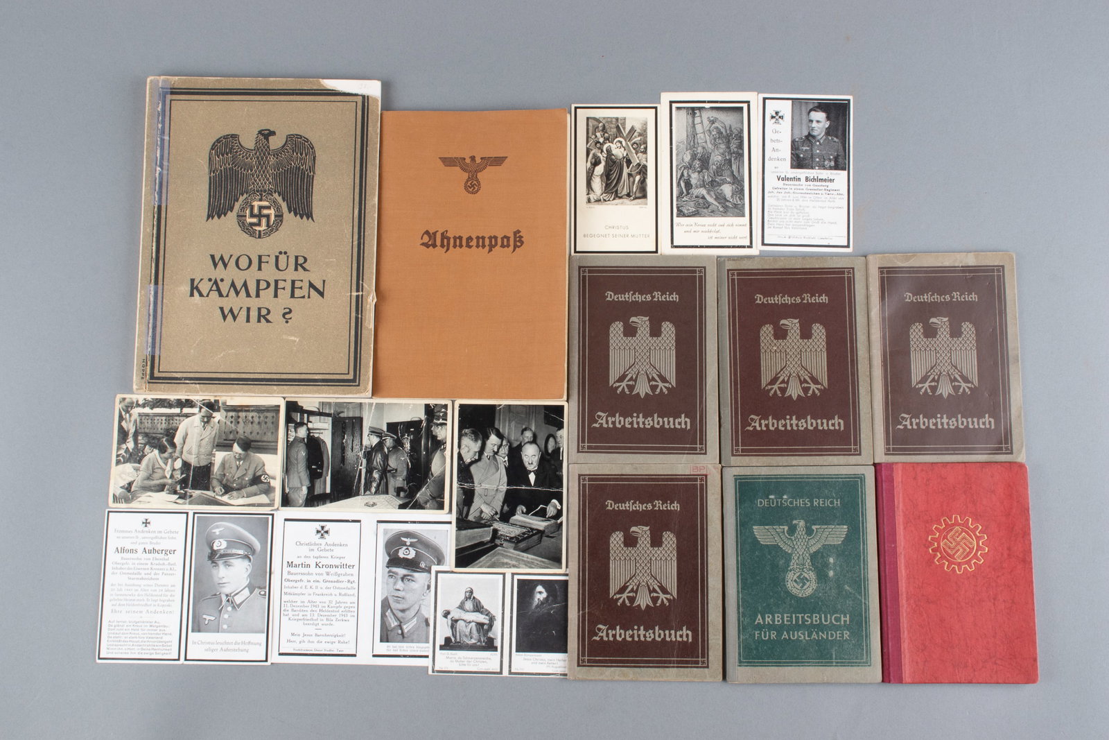 WWII GERMAN EPHEMERA [DEATH CARDS, WORKBOOKS]: WWII German workbooks, death cards, and photos. Including three b/w Adolf Hitler cigarette cards, six Heer death cards for soldiers killed between 1943 and 1945, four German workbooks, one foreign wor