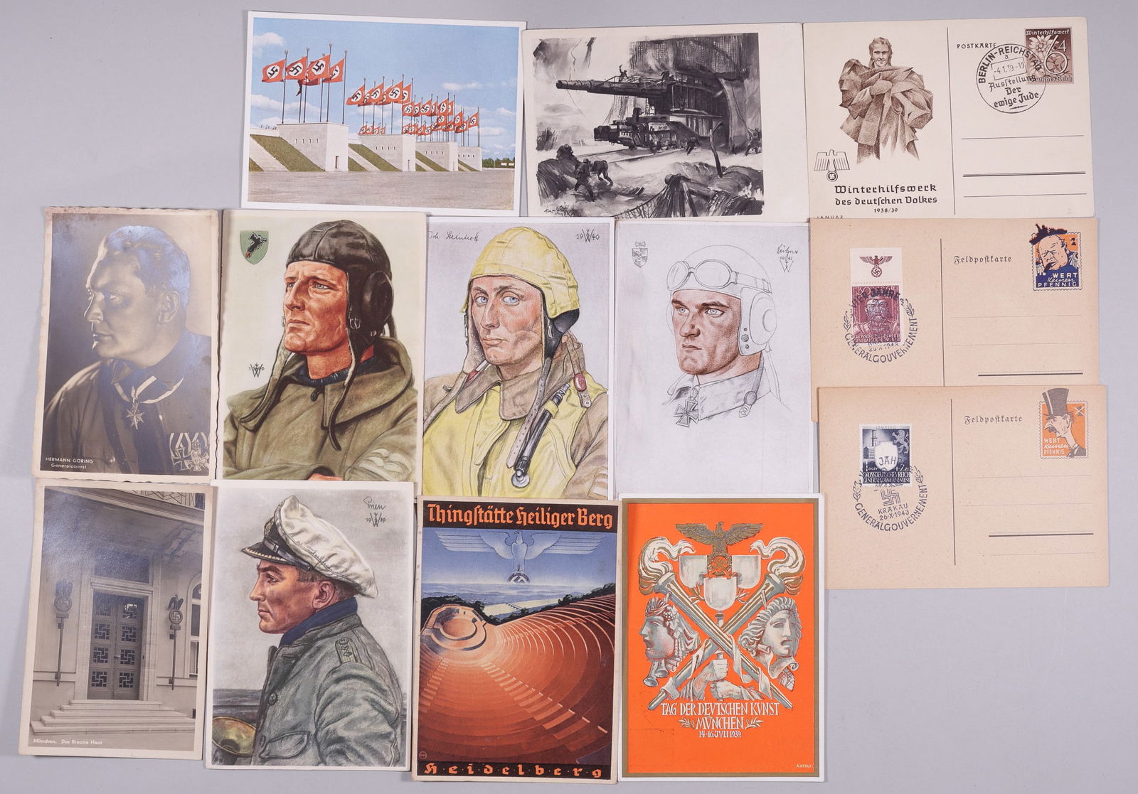 13 WWII GERMAN PATRIOTIC POSTCARDS: Thirteen WWII German patriotic postcards, including four Willrich postcards featuring Luftwaffe members, a portrait postcard photo of Hermann Goering, a photo postcard of the Brown House in Munich, a
