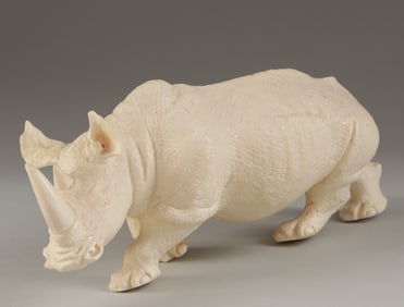 AFRICAN CARVED IVORY SCULPTURE OF A RHINOCEROS