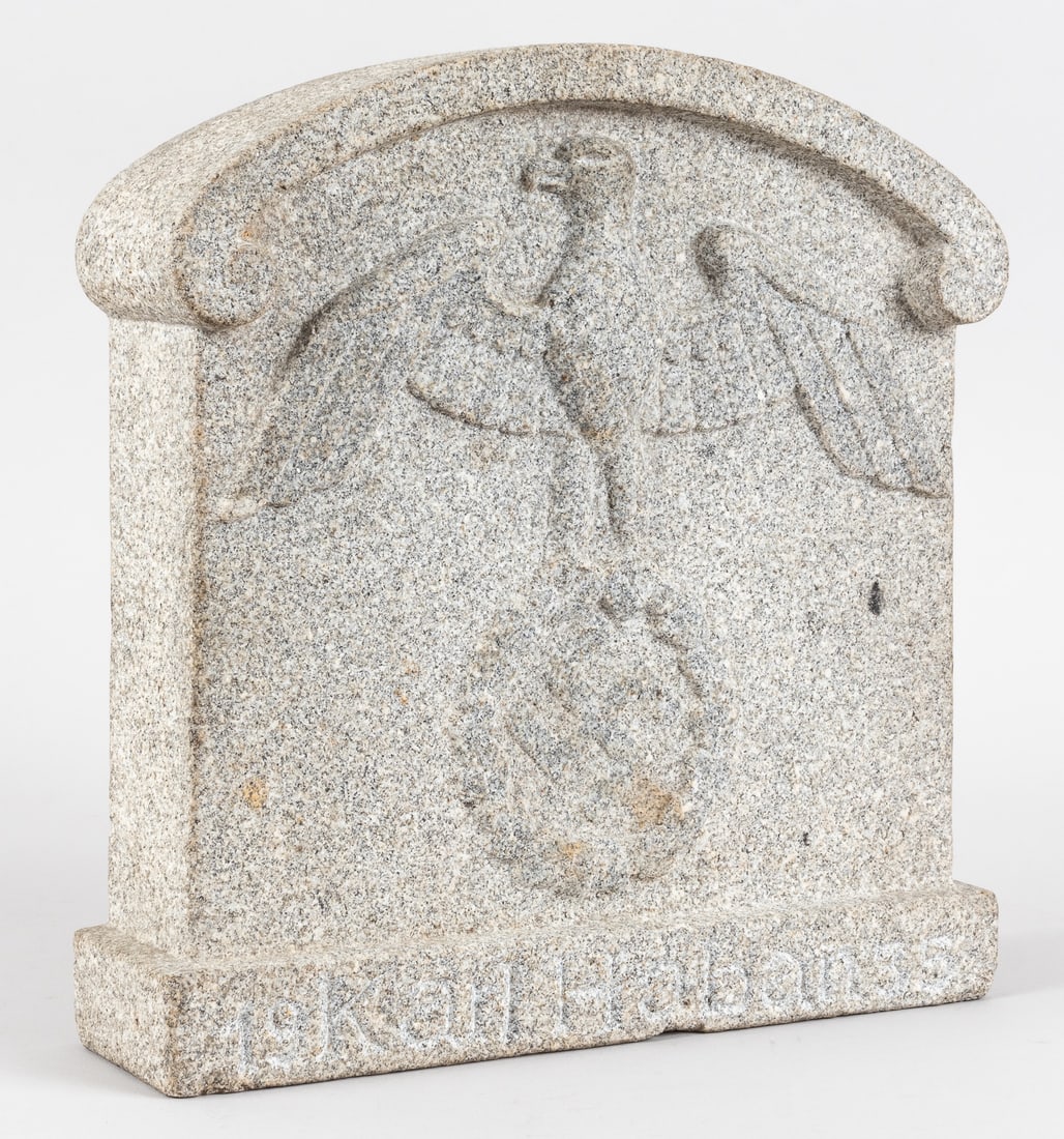 GERMAN REICHSADLER EAGLE SMALL HEADSTONE: Small stone or concrete headstone featuring a German Reichsadler eagle clutching a wreath with a swastika in the center. Inscribed along the bottom margins '19 Karl Haban 35.' 11 x 10.5 x 3 inches. We