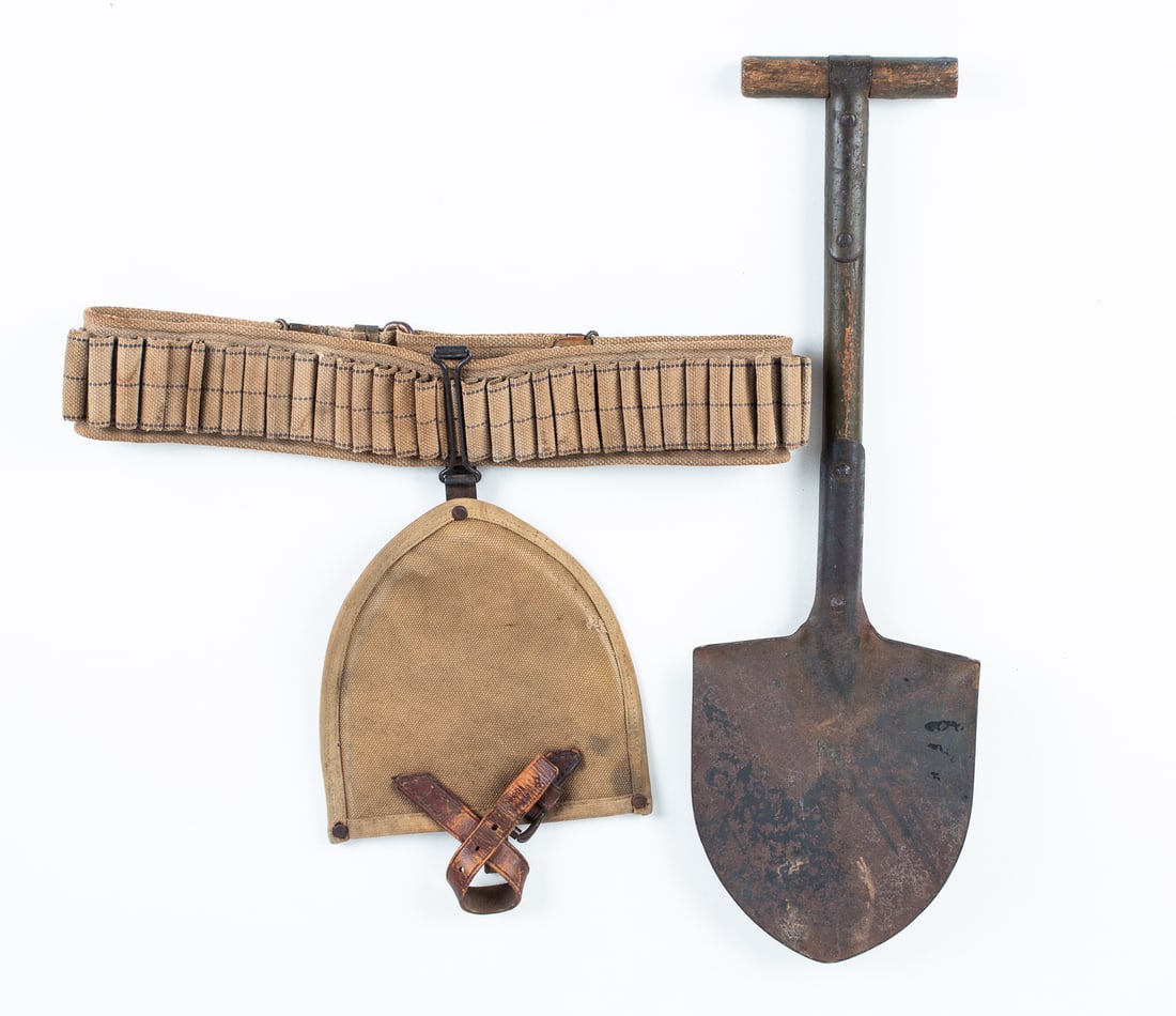 WWI AMERICAN AMMO BELT WITH TRENCH SHOVEL: WWI American ammo belt with hanging trench shovel, marked on the shovel reads 'R.I.A. 1908 / 9S-91,' the ammo belt is with many casing slots and is unmarked, the shovel is 22 inches long.
