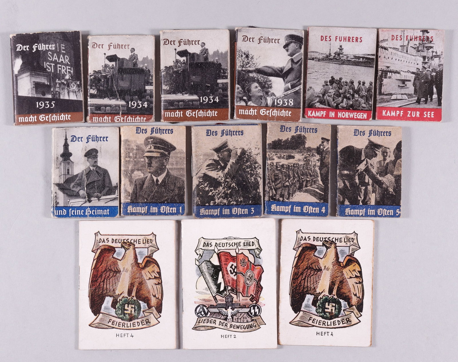11 ADOLF HITLER MINI BOOKS + 3 SONG BOOKS: Ten WWII WHW Winterhilfswerk Adolf Hitler books, including six of the blue series, four of the brown series, and two of the red series. Also including three German mini song books. 14 pieces total.