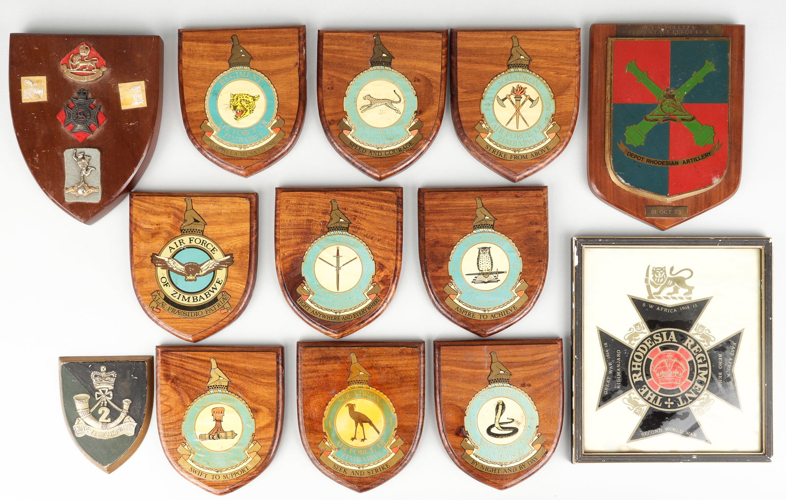 13 VINTAGE RHODESIAN ARMY & ZIMBABWE AIR FORCE WALL PLAQUES: Thirteen vintage Rhodesian Army and Zimbabwe Air Force insignia wall plaques, nine wooden wall plaques with an Air Force unit insignia decal on the front. 5 x 5.75 inches each. With a Rhodesian Regime
