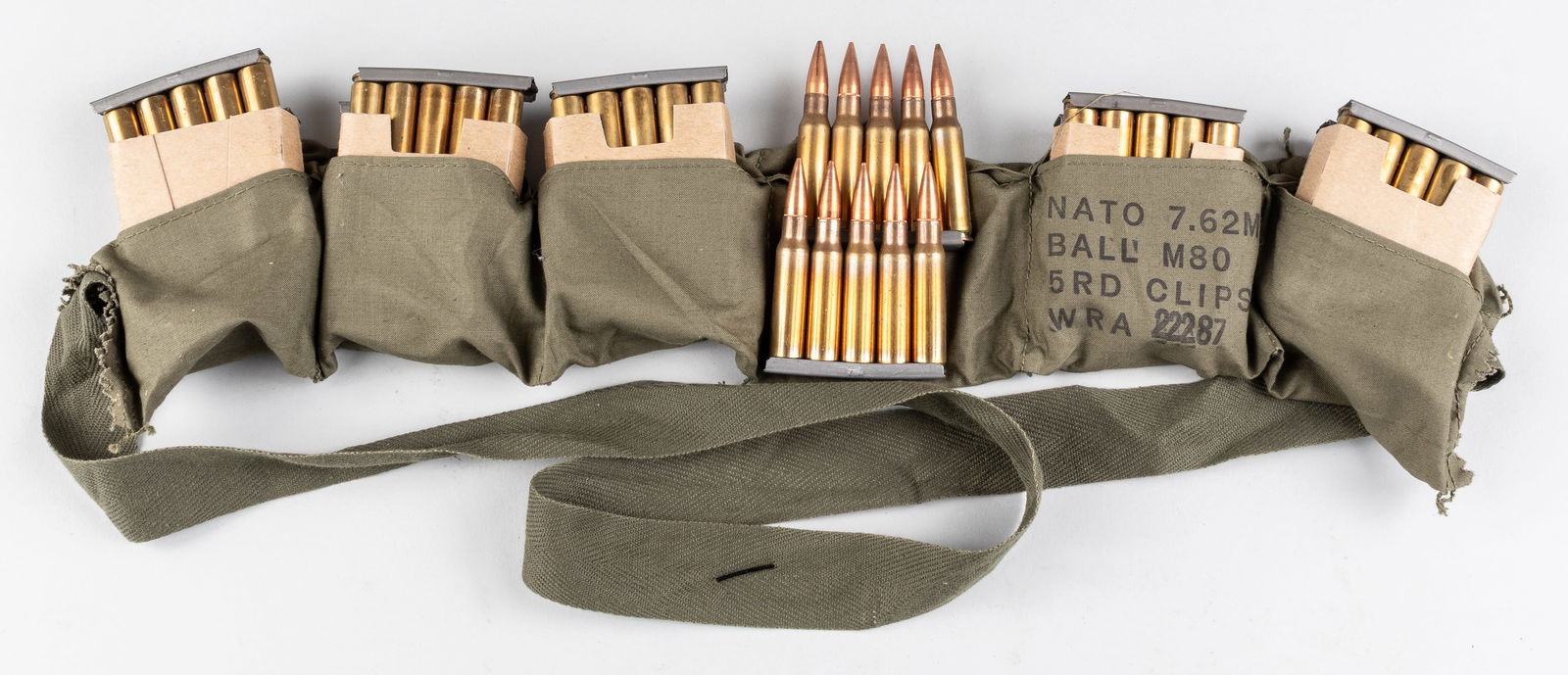 M2 BANDOLIER M14 WITH 12 CLIPS 60x 7.62MM ROUNDS AMMO: Vietnam War era American Army M2 cotton Bandolier with six pockets that were each designed to contain a cardboard sleeve holding two 5-round clips. Includes 12 clips, sixty 7.62mm rounds for the M14 r