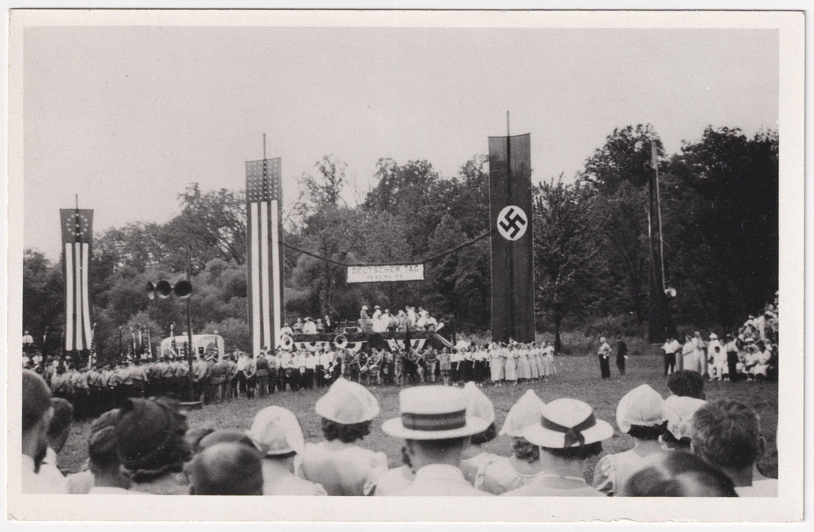 GERMAN AMERICAN BUND RALLY PHOTOGRAPH: Scarce German American Bund photograph from a rally at Carsonia Park, near Reading, PA., featuring a stage flanked by Nazi and American flags, with many Hitler Youth in attendance, at the top of the s