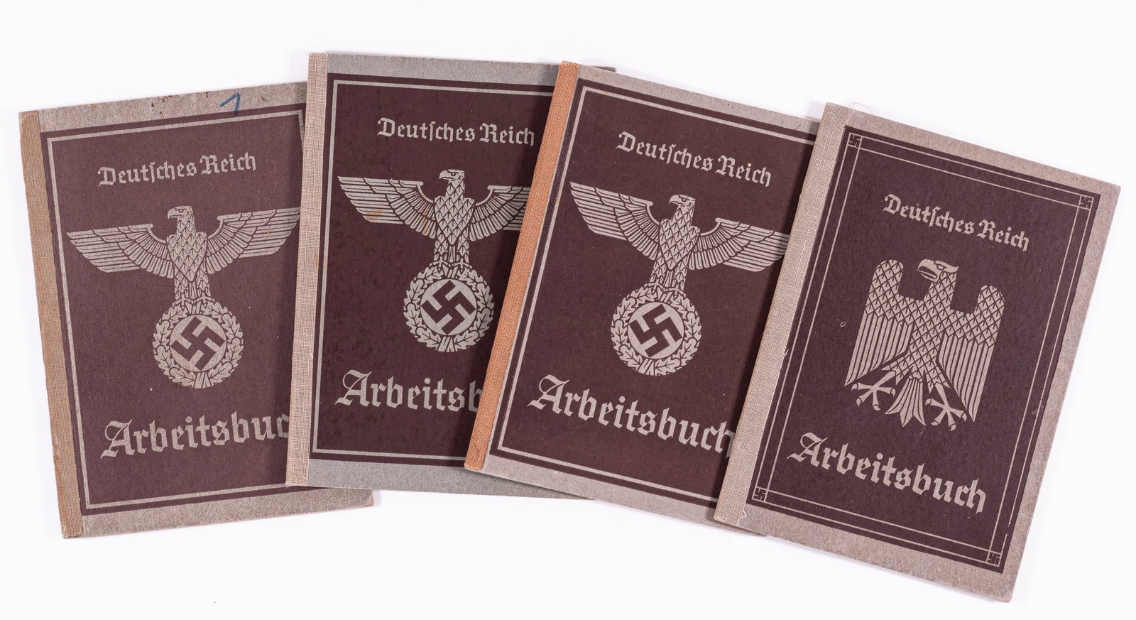 4 WWII GERMAN LABOR WORK BOOKS / ARBEITSBUCH: Lot of four WWII German Labor work books for nationals, known as Arbeitsbuch or work books. Three second version books with the Nazi eagle and mobile swastika and oak leaf wreath, one first version bo