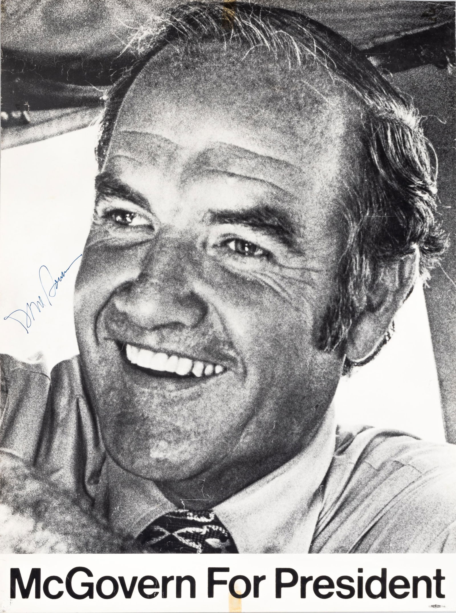 GEORGE MCGOVERN AUTOGRAPHED CAMPAIGN [2 POSTER LOT]: Two George McGovern presidential campaign posters. Autographed George McGovern campaign poster, 'McGovern For President,' signed in blue ink. Small tape bleeds from old tape, one small hole repair