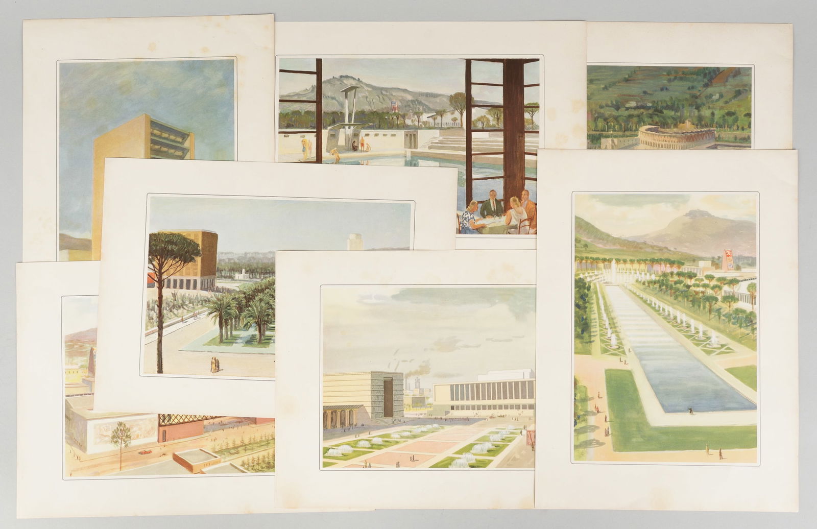 7 ITALIAN FASCIST ARCHITECTURE PAINTINGS 1940 EXHIBITION: Seven lithographs from the First Triennial Exhibition of the Italian Overseas Territories, opened by King Victor Emmanuelle in May 1940. An extraordinary piece of fascist-colonialist propaganda, it