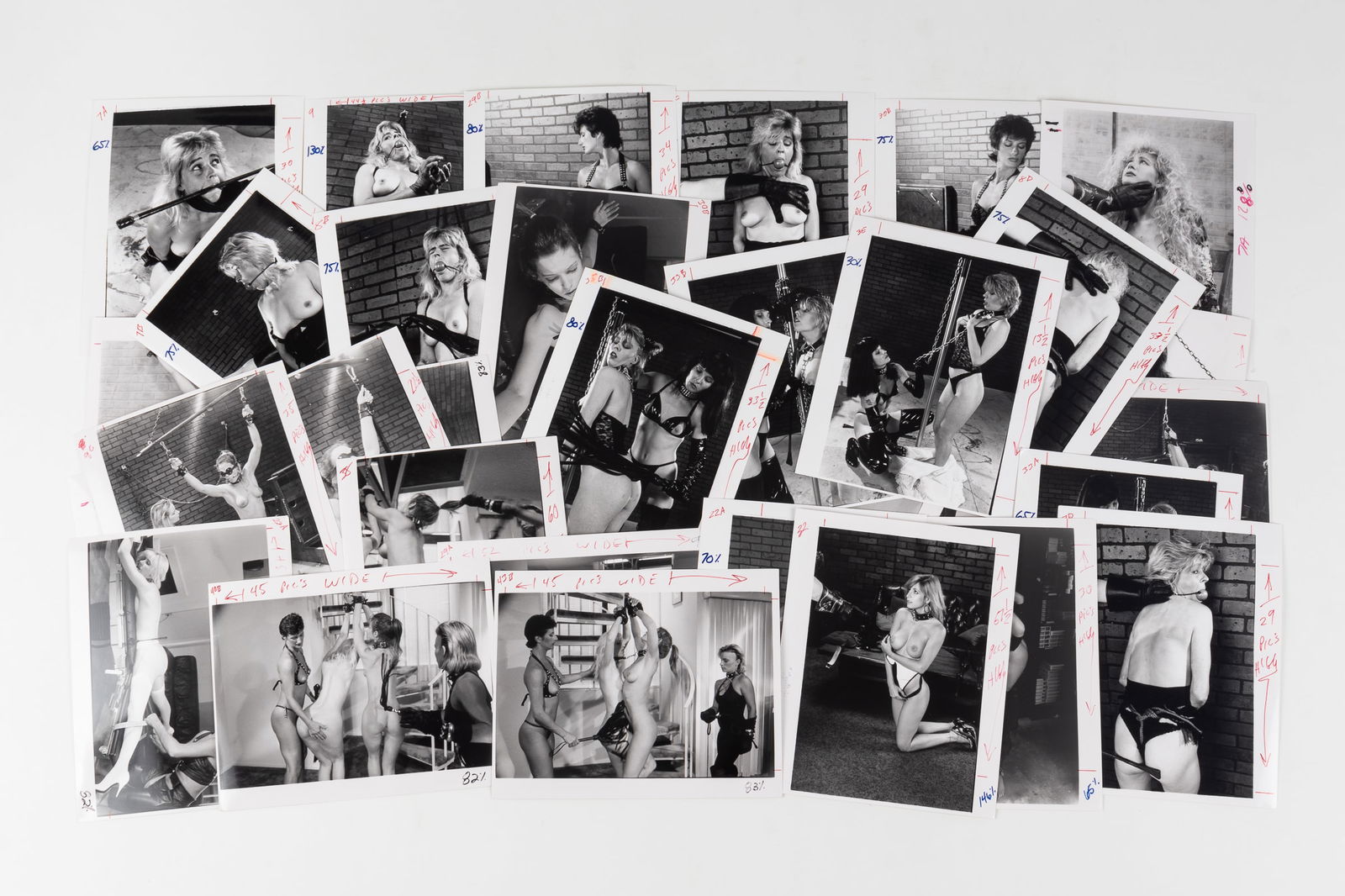 35 VINTAGE FETISH BONDAGE AND SPANKING PHOTOGRAPHS: Thirty-five vintage b/w adult fetish bondage and spanking erotic photographs, likely intended for magazine publishing, most with crop markings and instructions on the margins, 8 x 10 inches each.