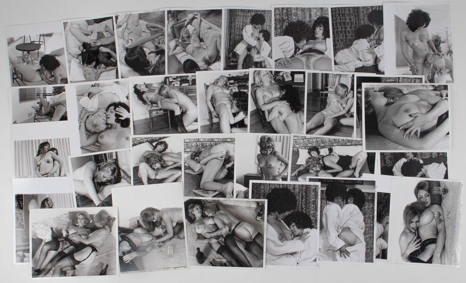 31 VINTAGE ADULT EROTIC LESBIAN PHOTOGRAPHS: Thirty-one vintage b/w adult lesbian erotic photographs, all from professional scenes, likely intended for magazine publishing, four without performer names on the reverse, 8 x 10 inches.
