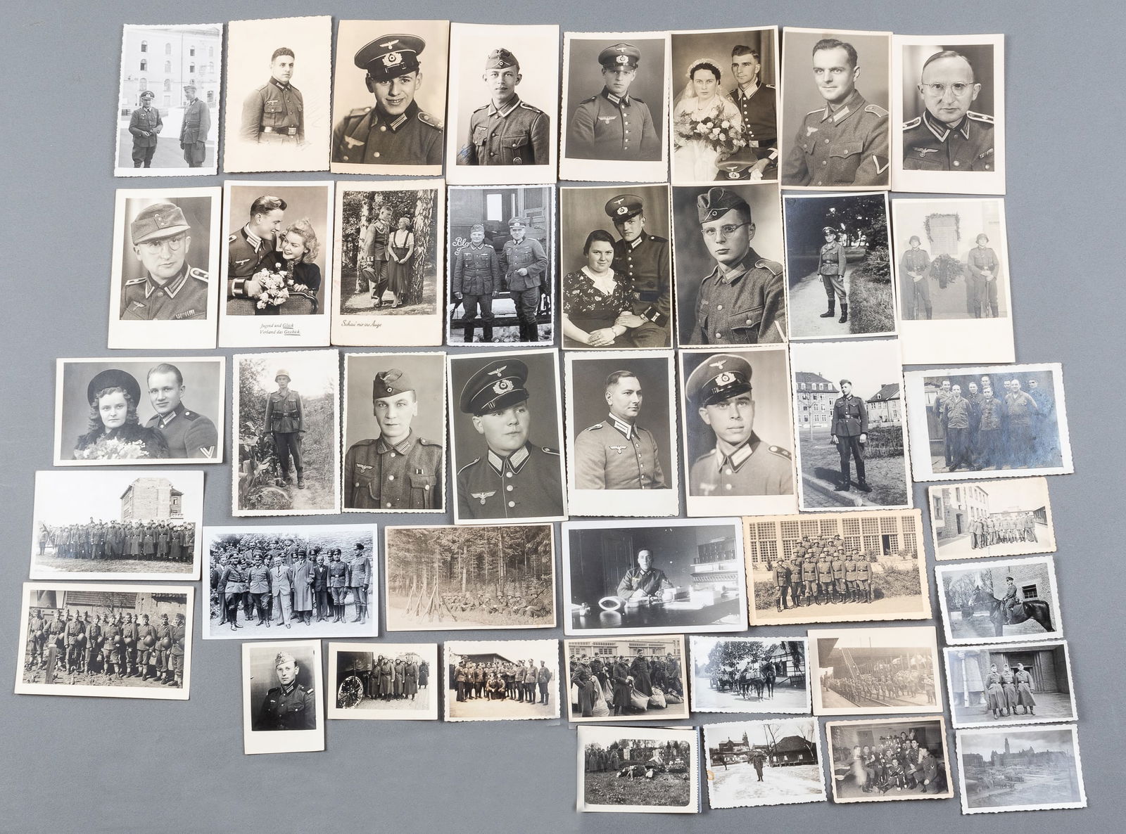 43 WWII NAZI PHOTOGRAPHS: Forty-three WWII Nazi b/w photographs, each photo including a member of the Wehrmacht, some photos group shots, some portrait photos, and some wedding photos with the soldier in uniform. The largest