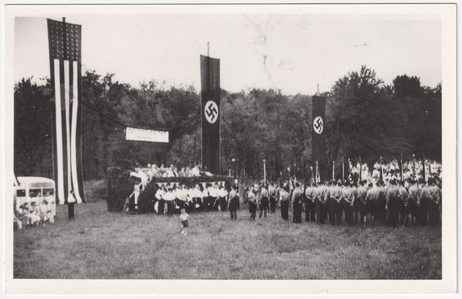 ORIGINAL GERMAN AMERICAN BUND NAZI RALLY PHOTOGRAPH: Scarce original German American Bund photograph from a Nazi rally at Carsonia Park, near Reading, PA., featuring a stage flanked by Nazi and American flags, with many Hitler Youth in attendance, at