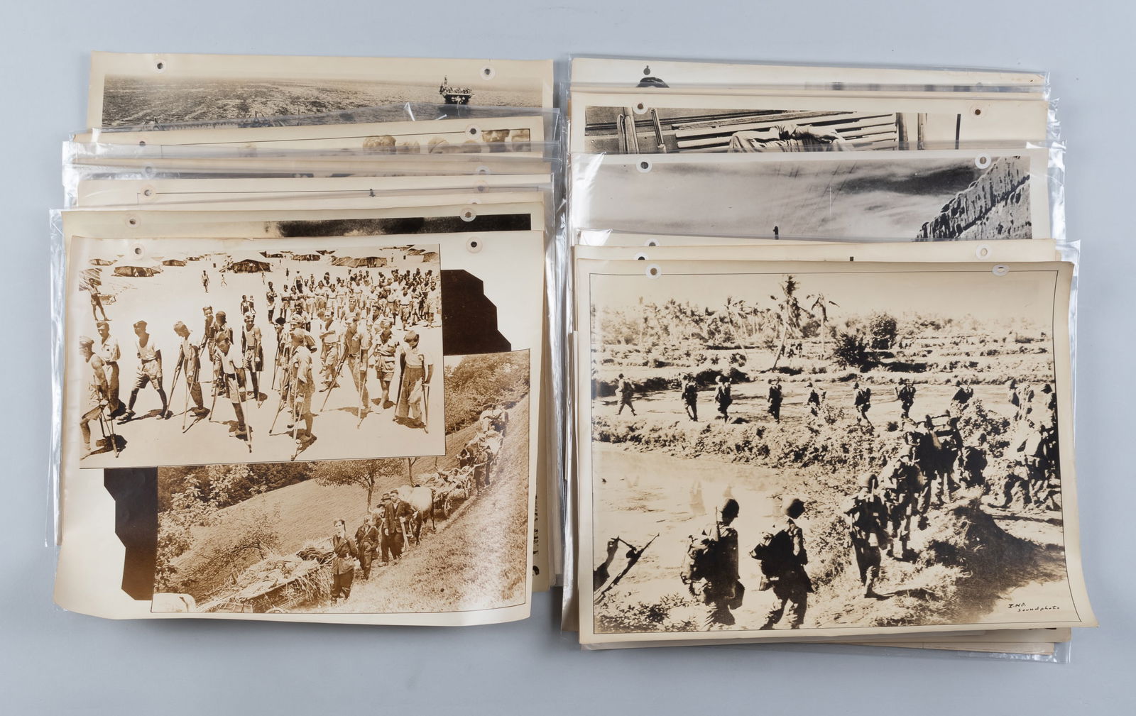 20 WWII US PROPAGANDA PHOTO POSTERS: Twenty WWII US propaganda photo posters, each with a caption on the reverse relating to the photo, some include 'Navy Greetings for Jap Iron Works,' 'First Red Cross in the Philippines,' 'For War -