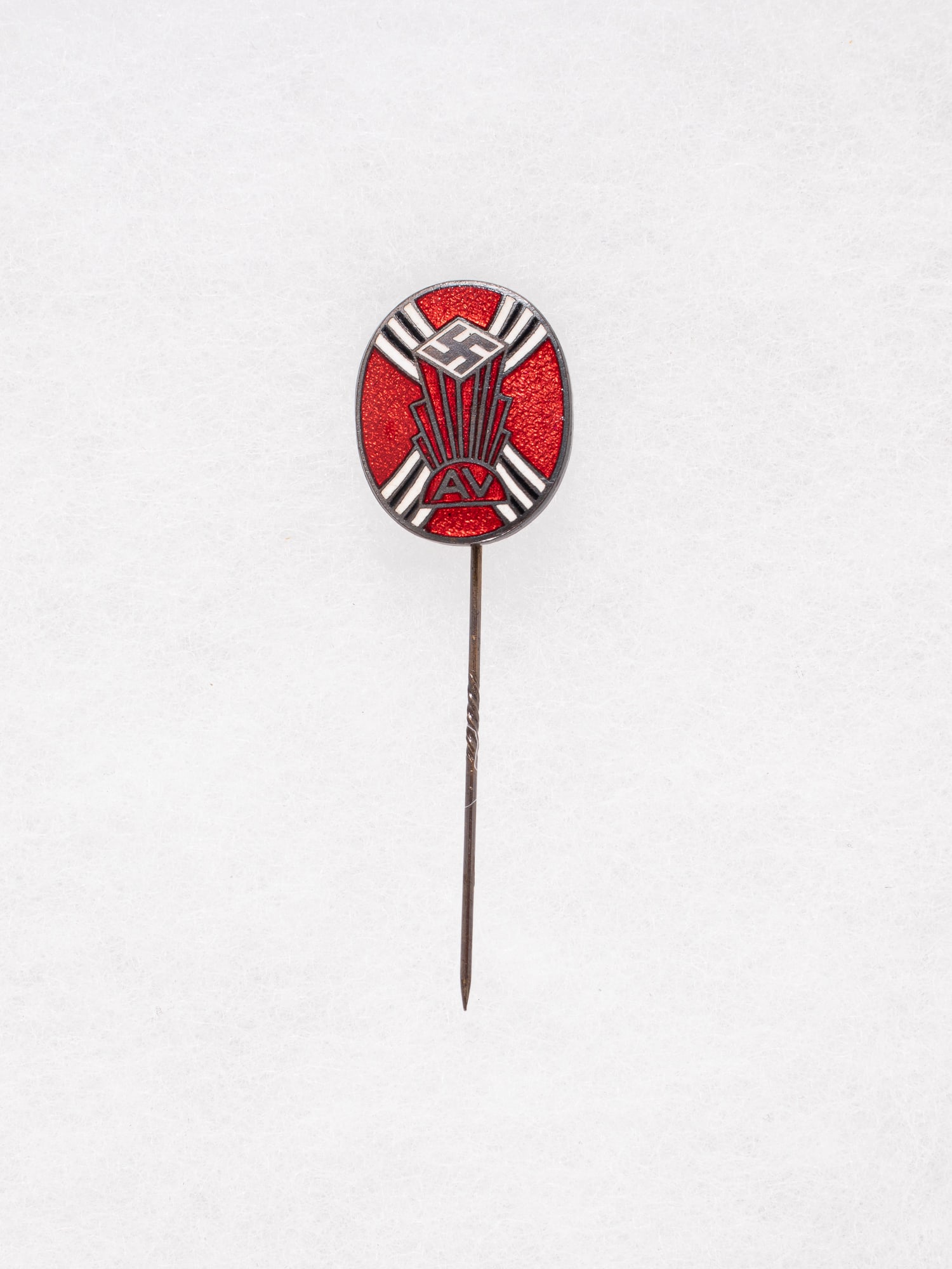 GERMAN AMERICAN BUND STICK PIN: German-American Bund lapel stick pin, tri-color red enamel with swastika in the center, four white triple sun rays and the letters 'AV' at the base, marked on the reverse for maker 'Apollo Jewelry Brk