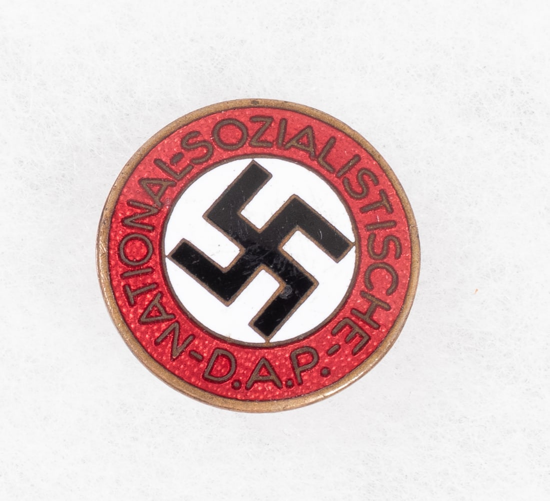 VERY RARE AUSTRIAN NAZI PARTY BADGE FRANZ JUNGWIRTH: Very rare Austrian Nazi Party membership badge, marked on the reverse 'RZM M1/152' for Austrian badge maker Franz Jungwirth. Heavy scratching and a minor chip to the white enamel, 20 mm in diameter.