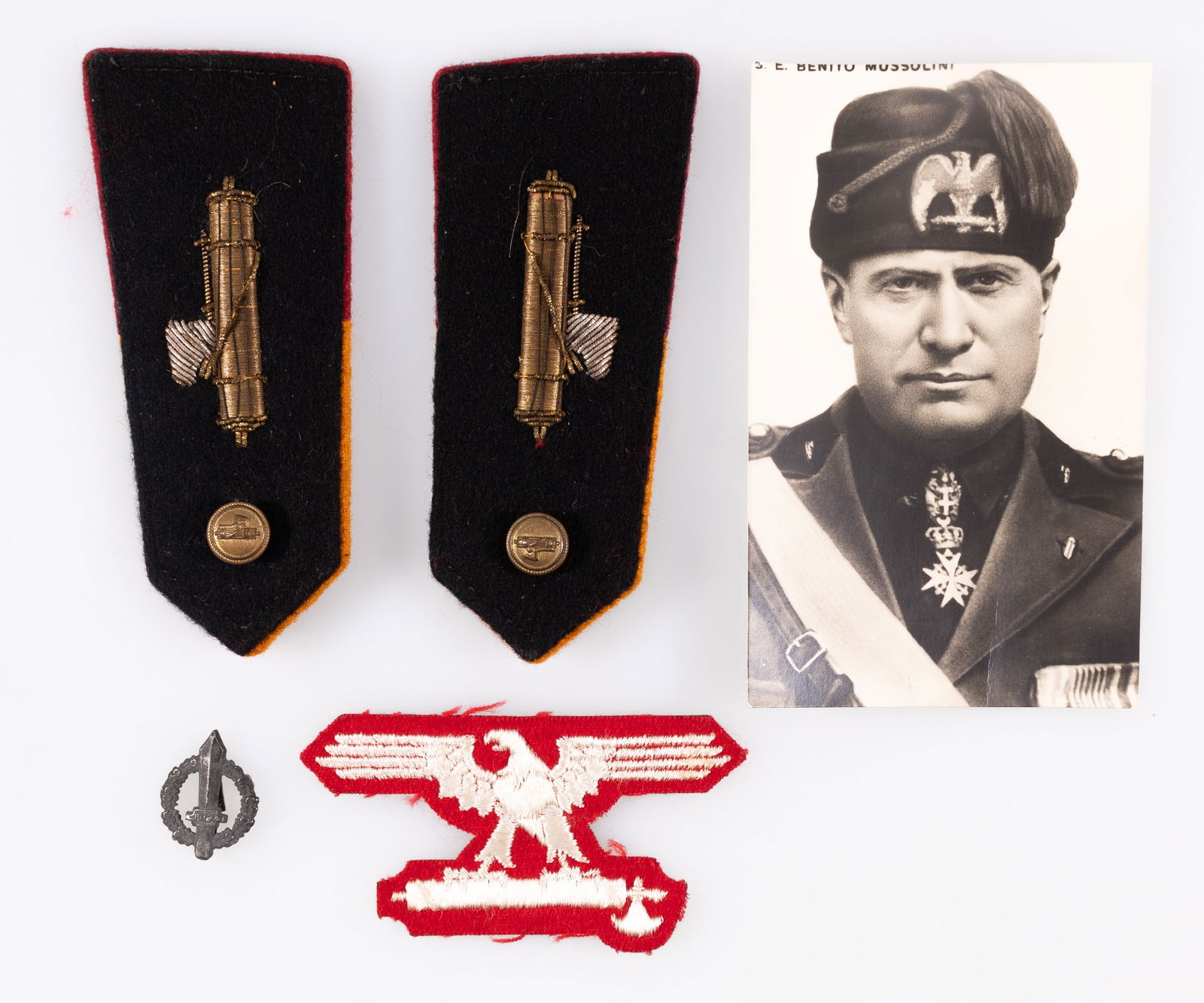 4 WWII ITALIAN PNF INSIGNIA AND PINS: Four Italian PNF insignia and pins, including an Italian Waffen-SS sleeve eagle, white eagle on a red background, an RSI Gladius collar pin insignia, and a pair of PNF shoulder boards, feature a gold
