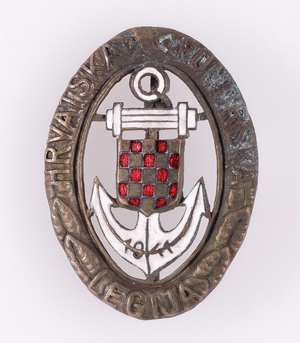 WWII CROATIAN NAVAL LEGION BADGE IN GOLD: WWII Croatian Naval Legion badge in gold, dated 1941 at the bottom of the badge, hollow badge, partially enameled, simple c-clasp pinback. 48 x 35 mm.