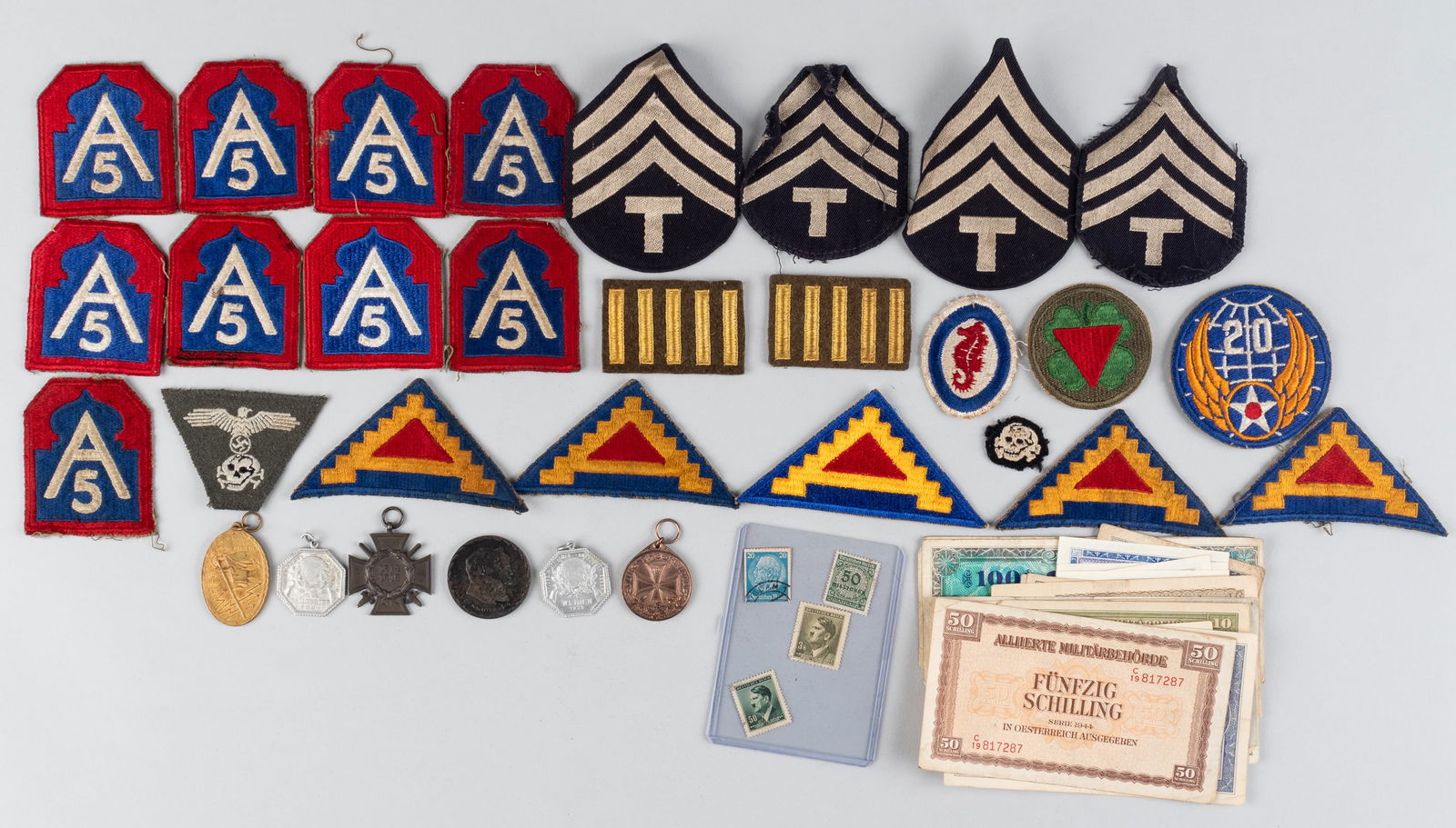 WWII AMERICAN PATCHES AND BRINGBACK SOUVENIERS: Collection of WWII American patches and possible bring-back souvenirs. Souvenirs including a Waffen-SS M43 cap eagle and skull patch, a Waffen-SS skull from the M43 cap patch, a Weiden 1922 tinnie, a