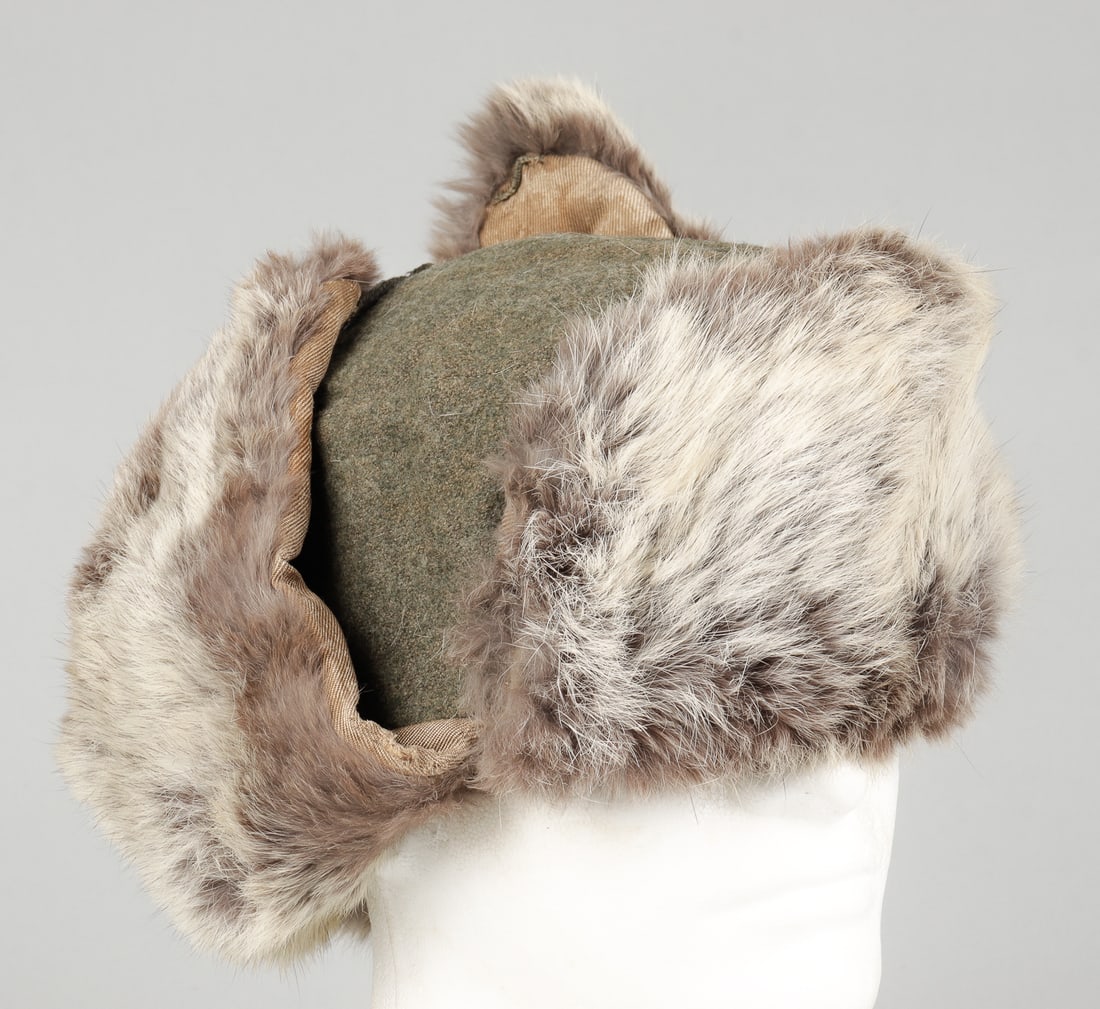 WWII GERMAN HEER RABBIT FUR HAT: WWII German Heer rabbit fur hat, marked 1943 on the interior of the hat with other illegible markings above, thick cloth hat with rabbit fur stitched along the outside of the hat, one of the chinstrap